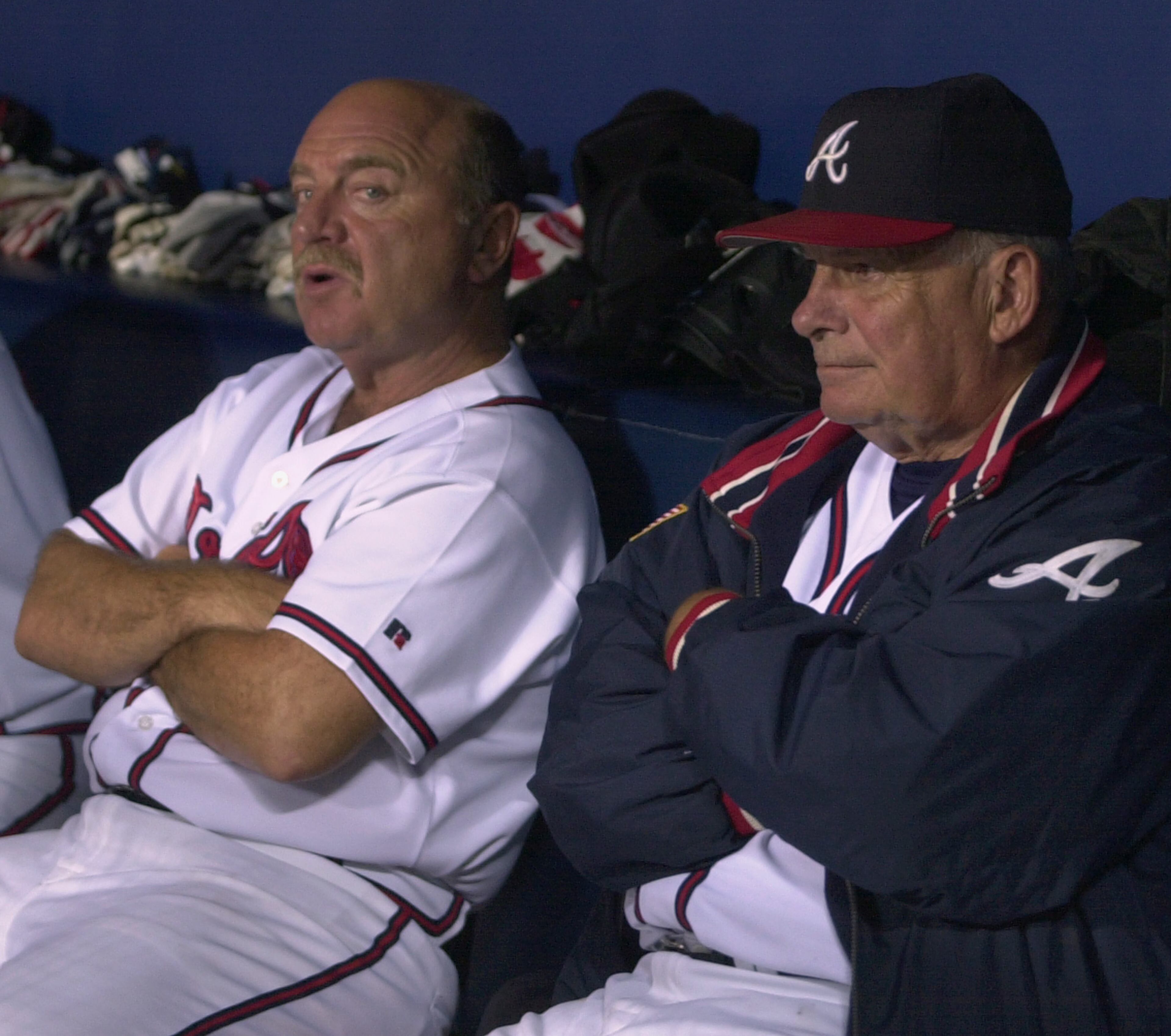 Braves manager Bobby Cox, right, sits with Mazzone in the dugout on Sept. 22, 2003 at Turner Field.