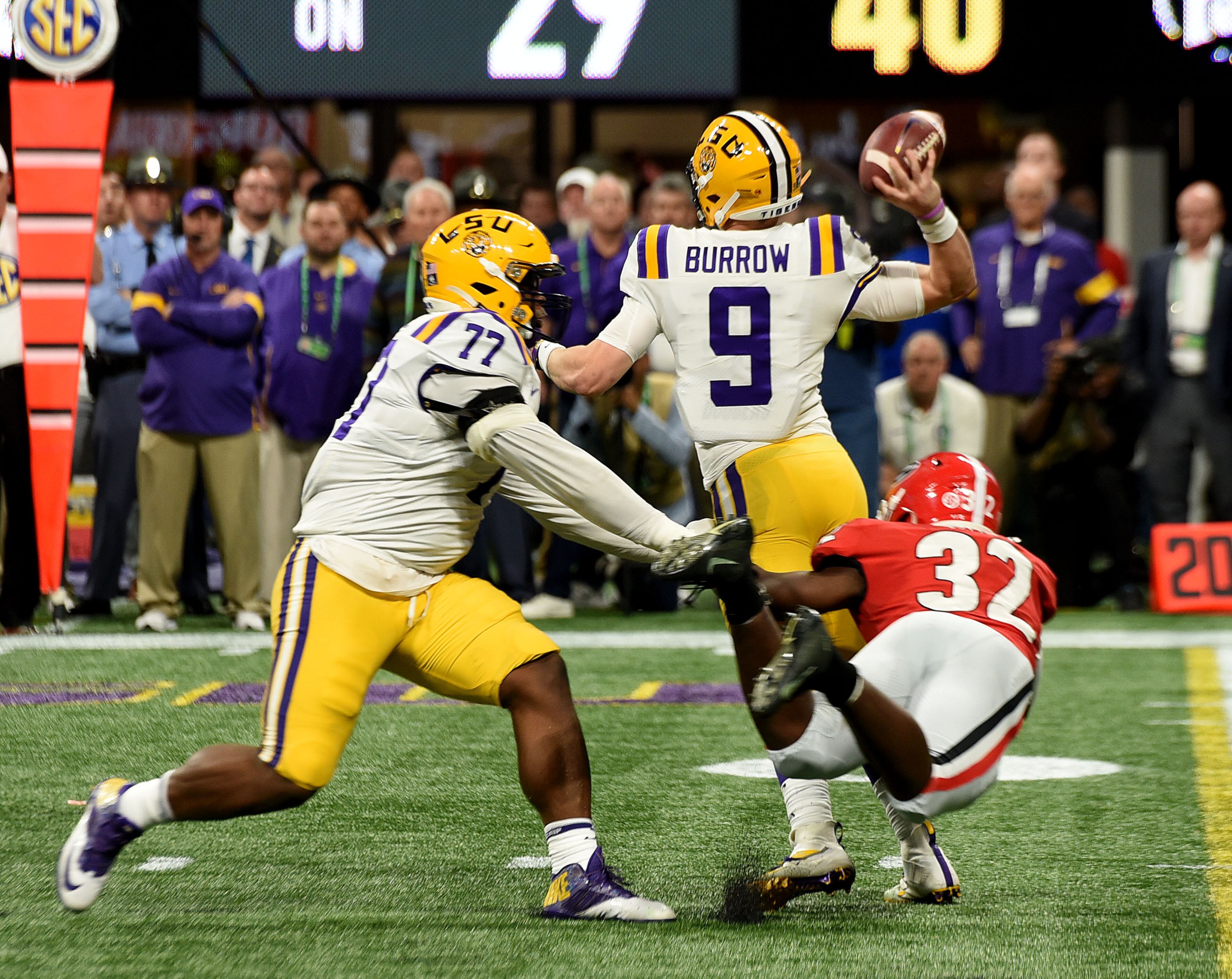 LSU quarterback Joe Burrow (9) gets a little pressure in the pocket from Georgia linebacker Monty Rice (32) in the second quarter, during the Georgia vs. LSU SEC Football Championship game at Mercedes-Benz Stadium in Atlanta. Ryon Horne/RHORNE@AJC.COM