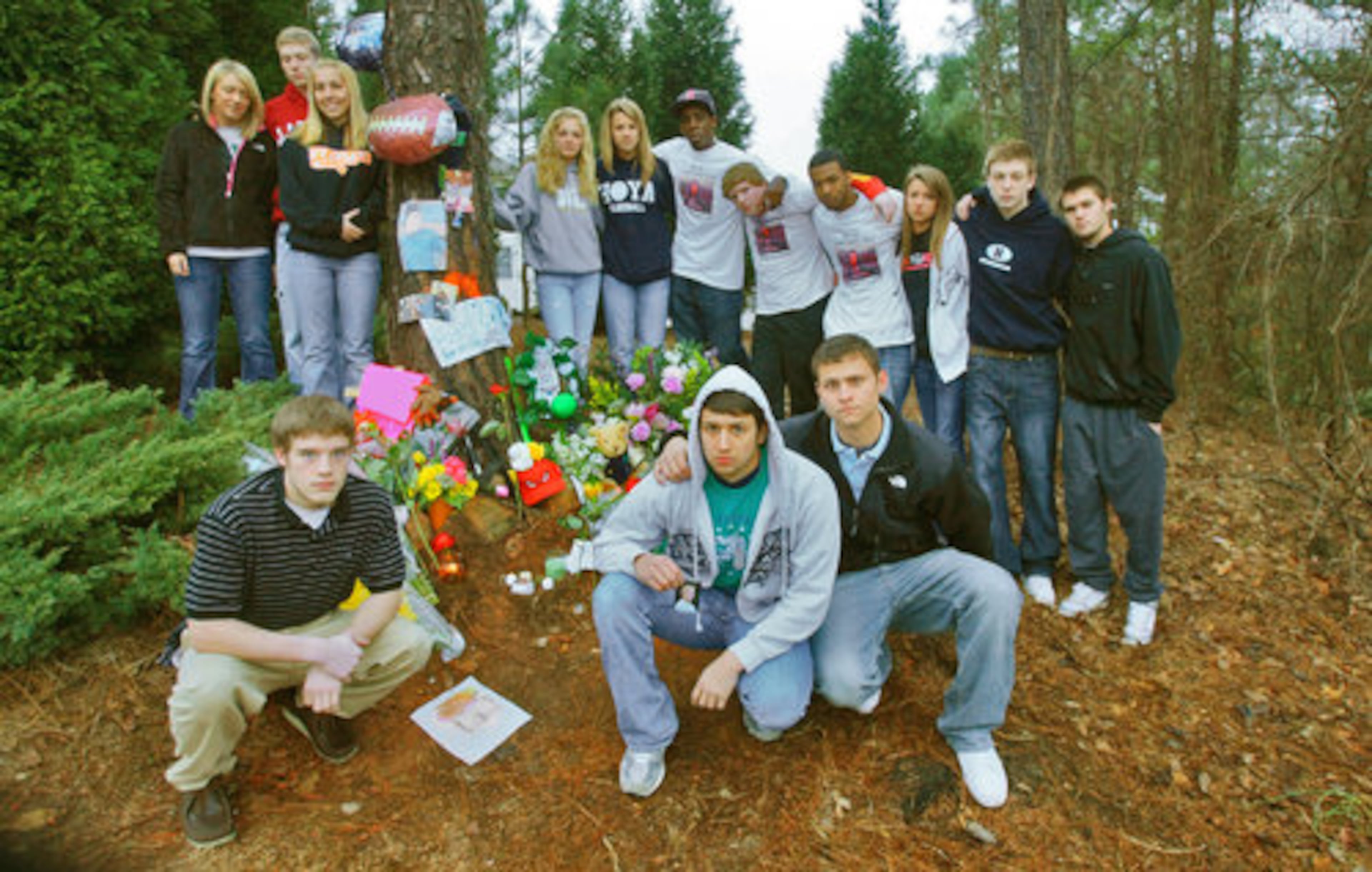 Friends gather at the roadside memorial. The funeral for Garrett Reed will be at 2 p.m. Tuesday at First Baptist Church in Powder Springs.