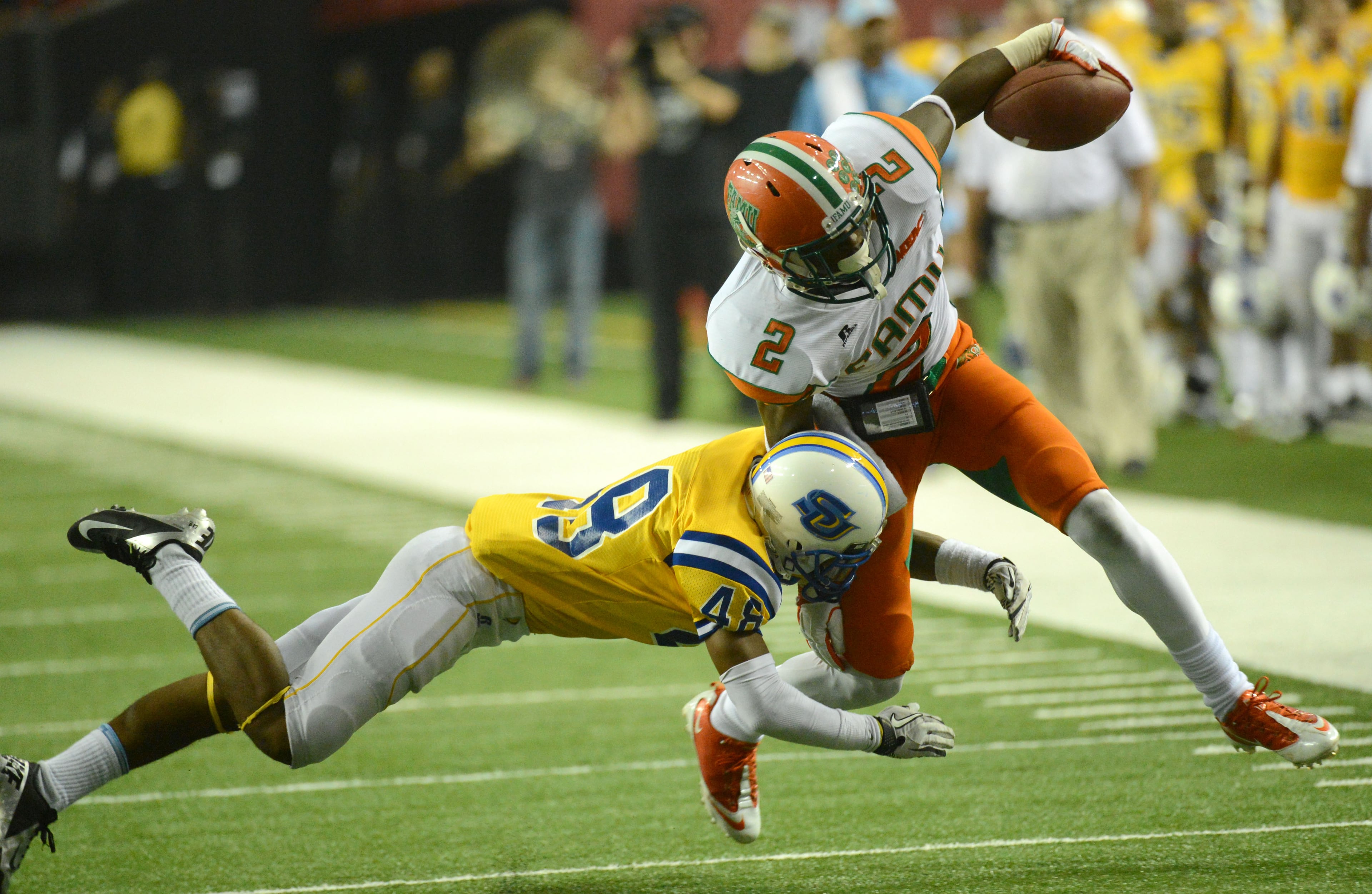 Florida A&M wide receiver Travis Harvey (2) is pushed out of bounds by Southern defensive back Marquon Webster (48) in the second half during the 2012 Bank of America Atlanta Football Classic at the Georgia Dome on Saturday, September 29, 2012. Southern won 21-14 over the Florida A&M.