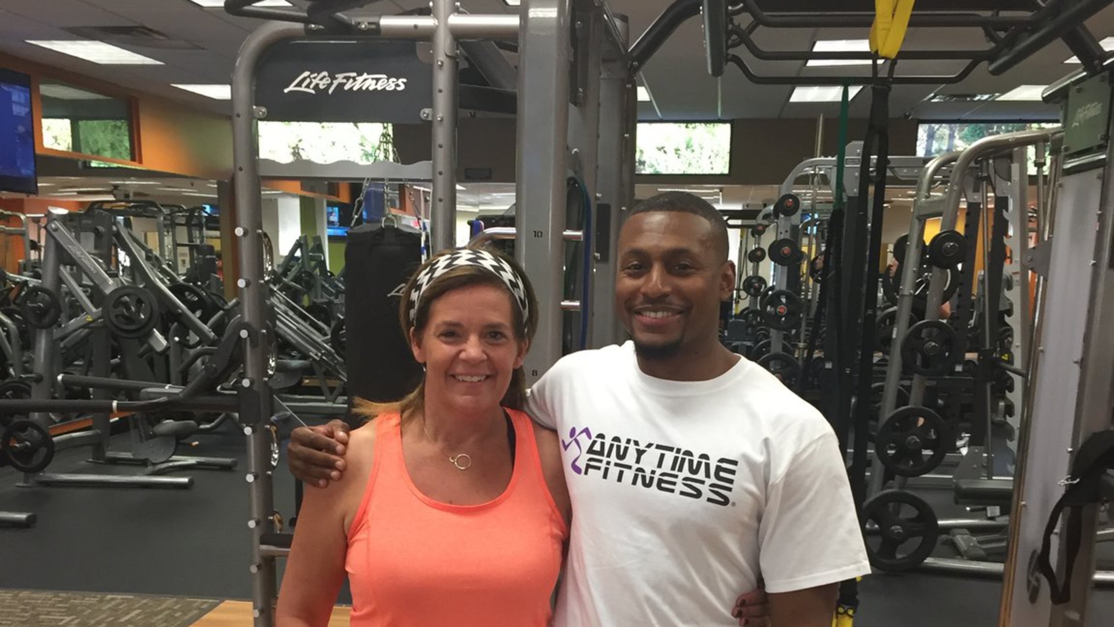 Janet Stallings at 145 pounds in October. With her is Justin Hunt, her personal trainer at Anytime Fitness in Towne Lake. (Justin Hunt)