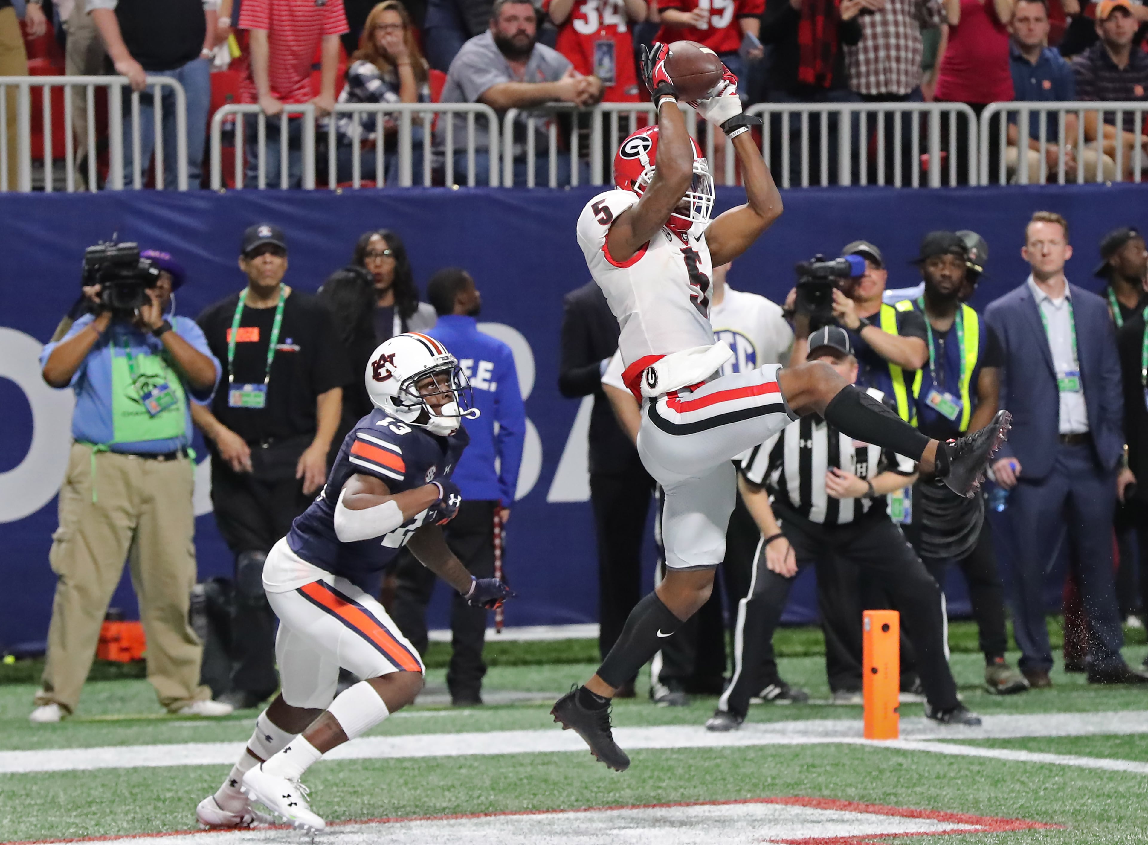 December 2, 2017 Atlanta: Georgia Bulldogs wide receiver Terry Godwin (5) catches a touchdown pass in front of Auburn Tigers defensive back Javaris Davis (13) during the second half of the SEC Football Championship at Mercedes-Benz Stadium, December 2, 2017, in Atlanta. Curtis Compton / ccompton@ajc.com