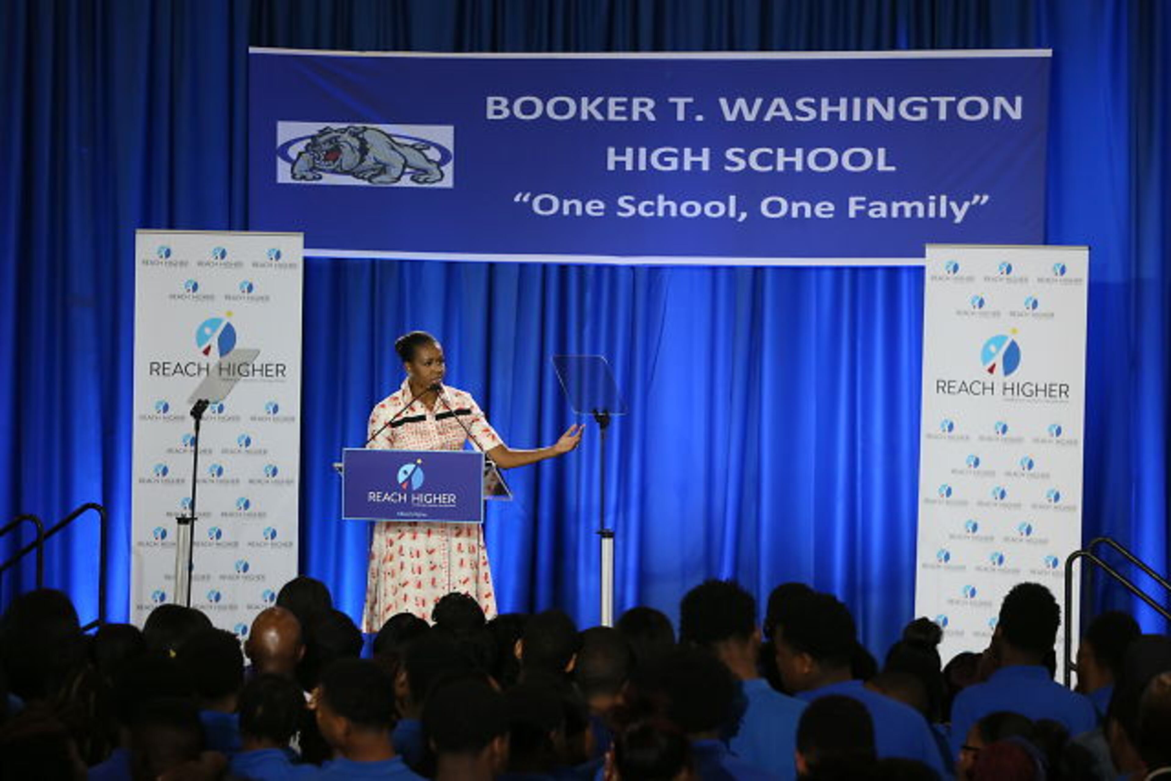 The first lady emphasizes the importance of students completing some form of higher education in a speech at Washington High School.