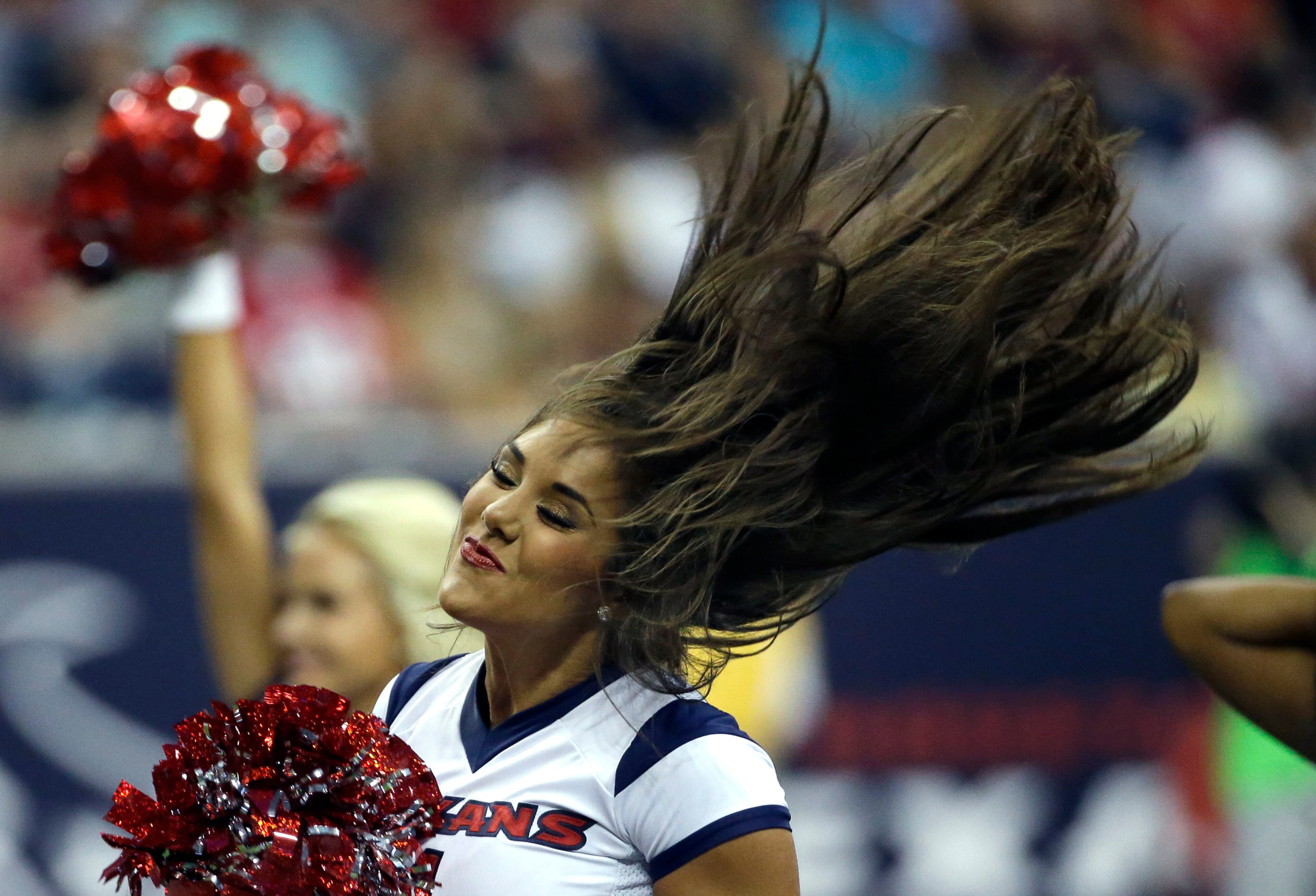 A Houston Texans cheerleader performs during the second quarter of an NFL preseason football game against the Atlanta Falcons Saturday, Aug. 16, 2014, in Houston. (AP Photo/David J. Phillip)