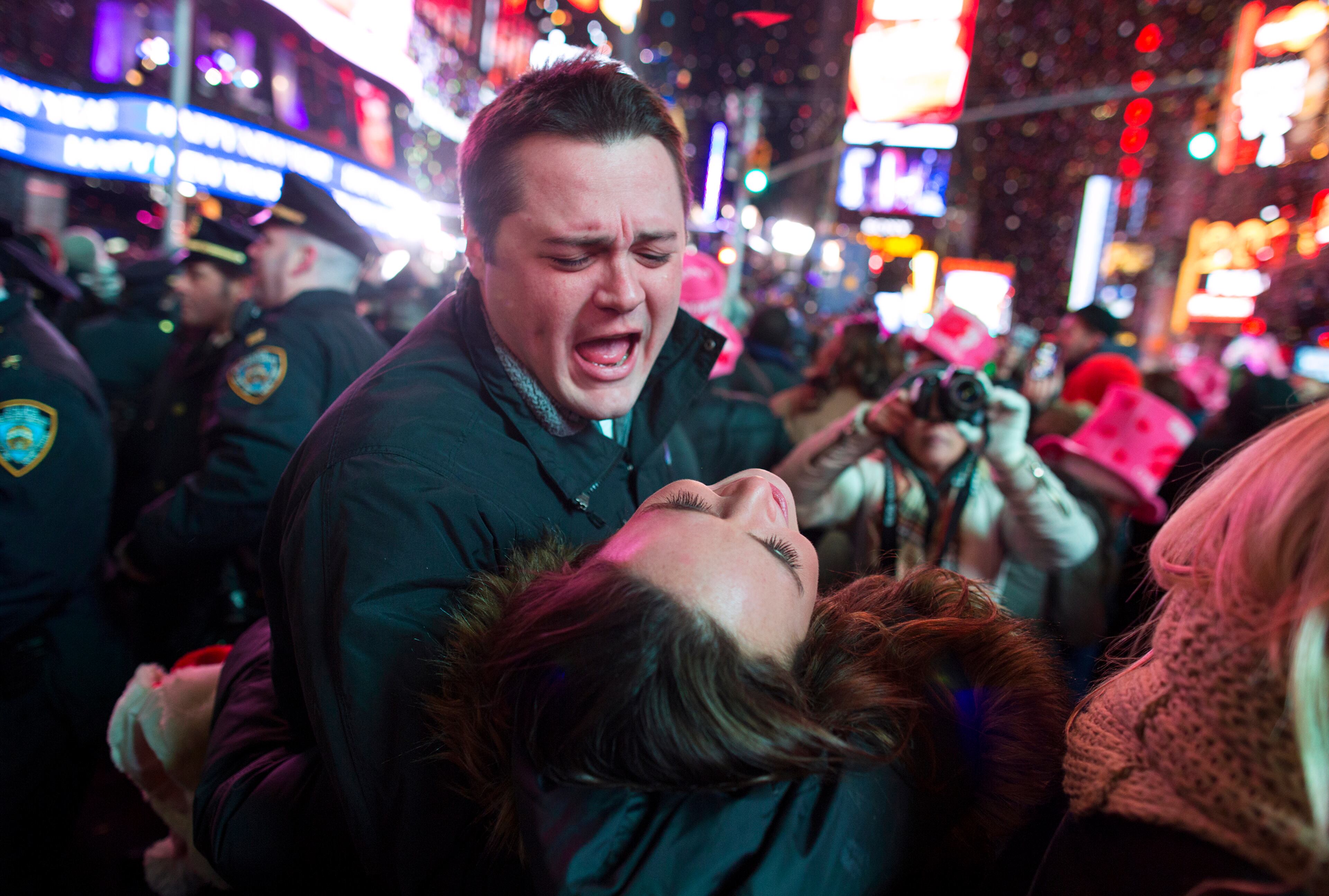 Tim Smithe and his wife Kyla-McCarthy-Smithe, of Chicago, celebrate in Times Square just after midnight during New Year's Eve festivities in New York, Thursday, Jan. 1, 2015. (AP Photo/Craig Ruttle)
