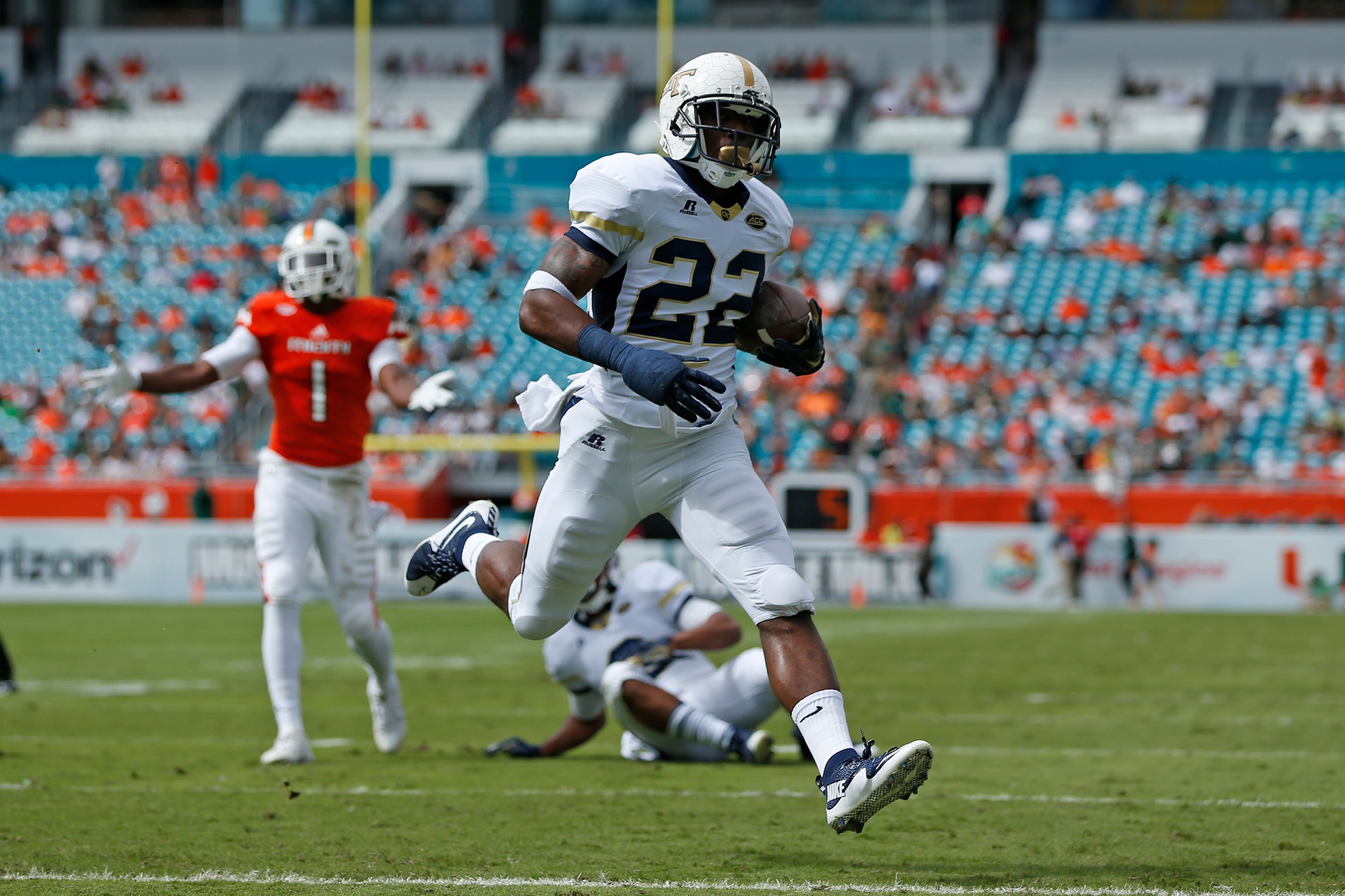 MIAMI GARDENS, FL - NOVEMBER 21: Broderick Snoddy #22 of the Georgia Tech Yellow Jackets scores a first quarter touchdown against the Miami Hurricanes on November 21, 2015 at Sun Life Stadium in Miami Gardens, Florida.(Photo by Joel Auerbach/Getty Images)