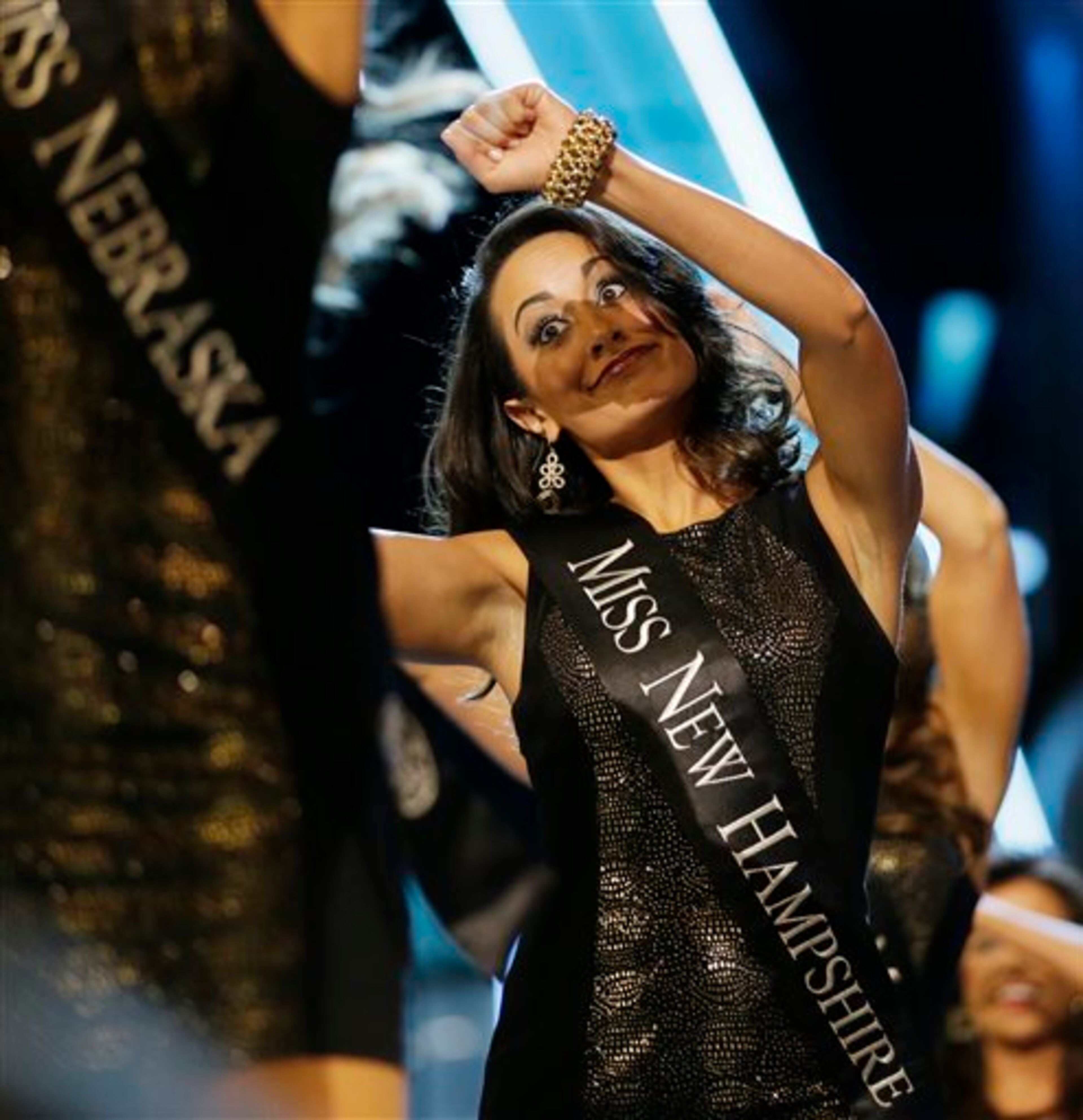 Miss New Hampshire Samantha Russo dances while walking with other contestants during the Miss America 2014 pageant, Sunday, Sept. 15, 2013, in Atlantic City, N.J. (AP Photo/Julio Cortez)