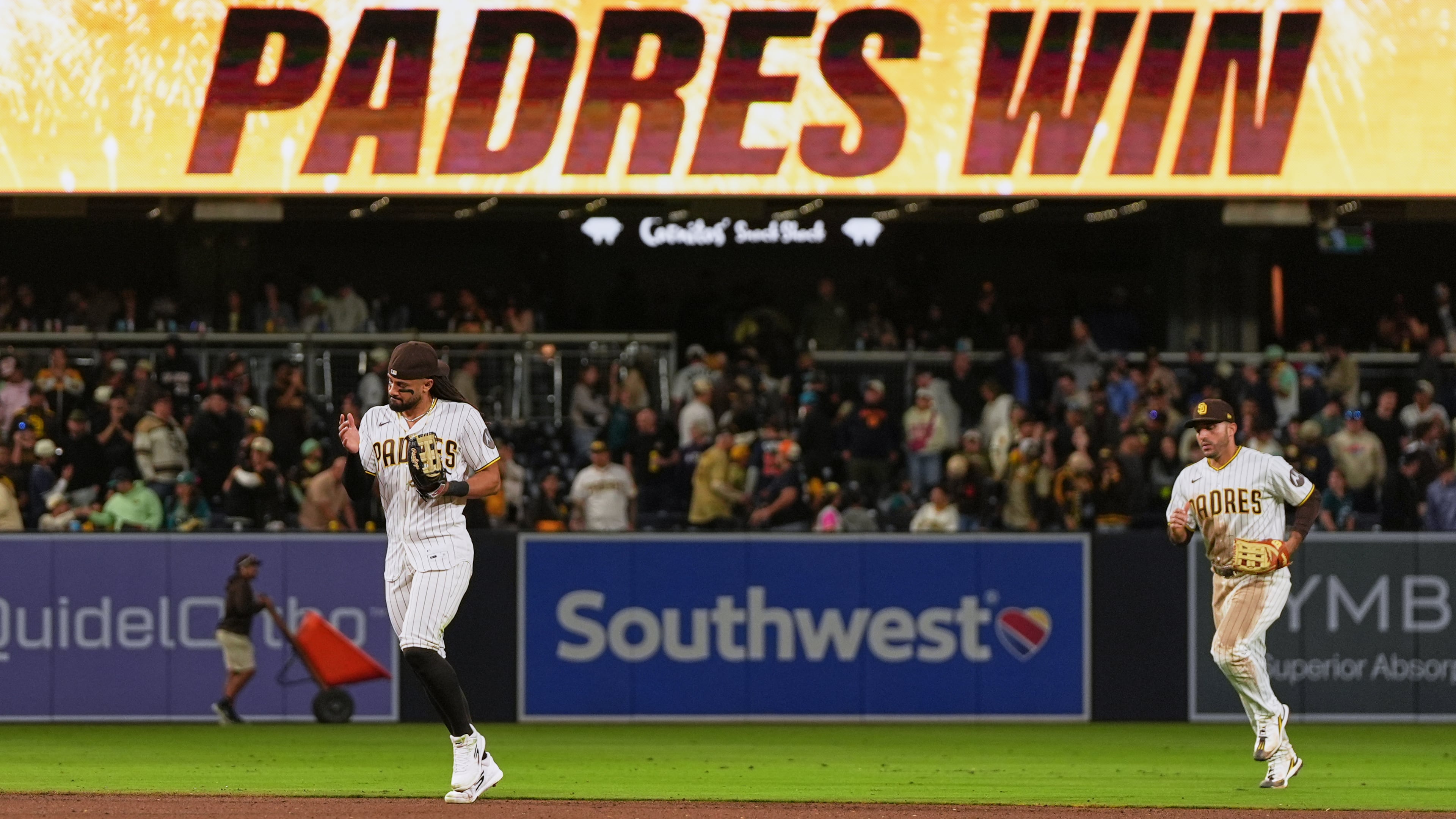 San Diego Padres right fielder Fernando Tatis Jr., left, and left fielder Ramón Laureano celebrate after the Padres defeated the Seattle Mariners 5-2 in a baseball game Thursday, April 16, 2026, in San Diego. (AP Photo/Gregory Bull)