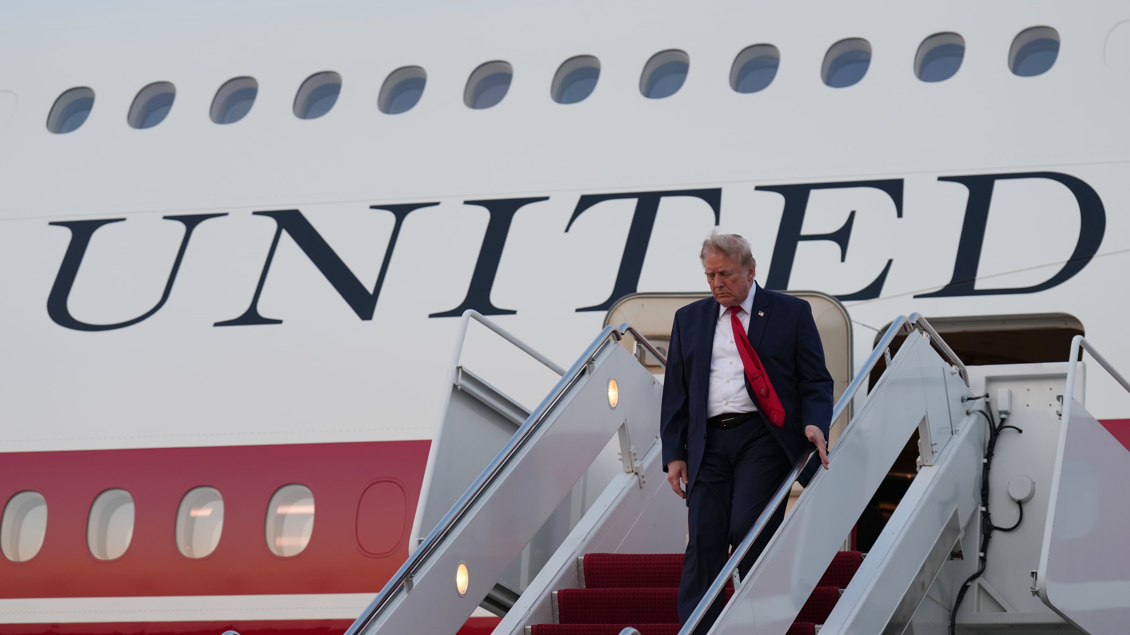 President Donald Trump exits Air Force One at Joint Base Andrews, Md., after attending the World Cup final soccer match, Sunday, July 19, 2026. (AP Photo/Jacquelyn Martin)