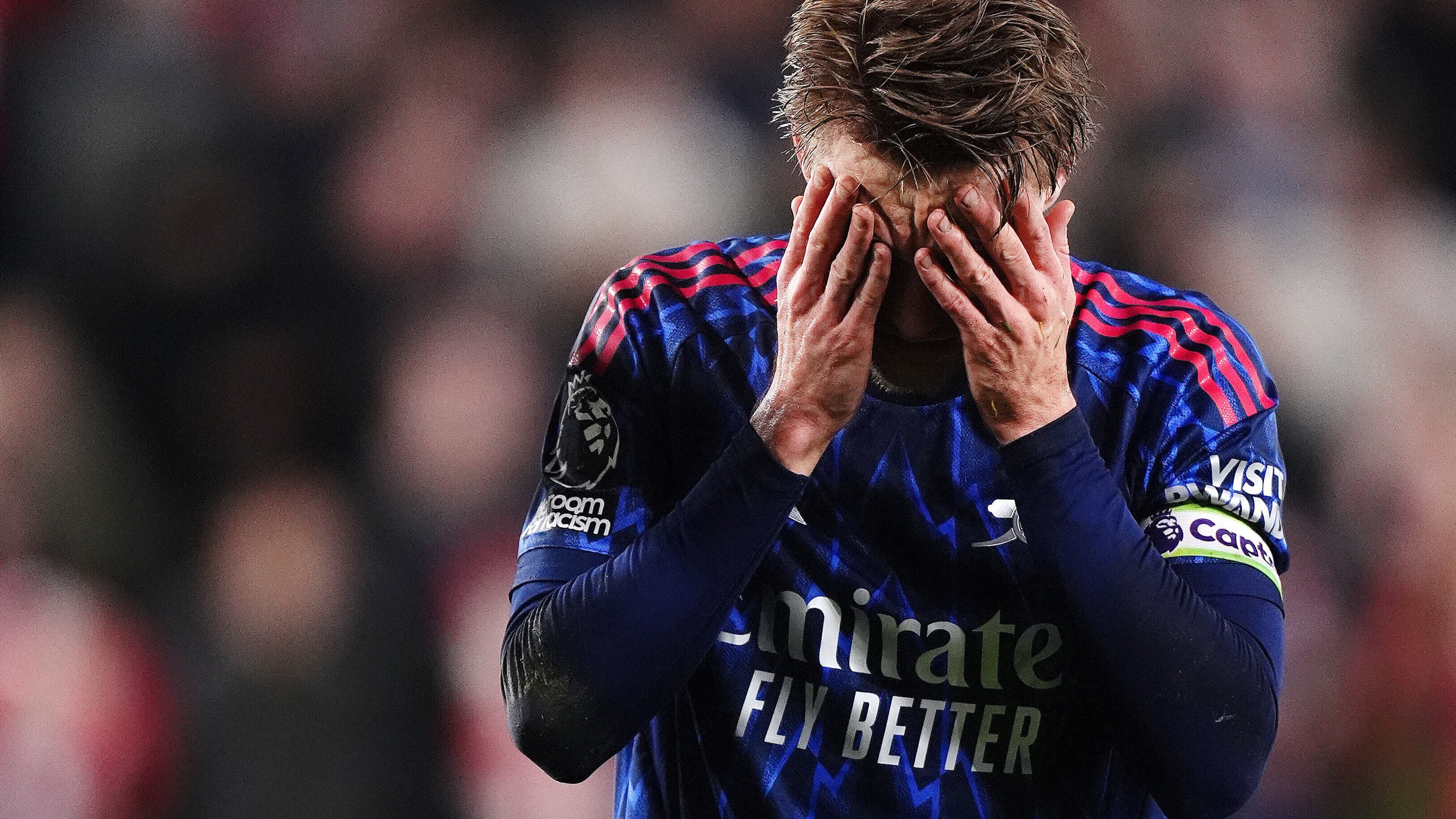 Arsenal's Martin Odegaard reacts after getting injured attempting to prevent Brentford's Keane Lewis-Potter from scoring during the English Premier League soccer match between Brentford and Arsenal in London, Thursday, Feb. 12, 2026. (John Walton/PA via AP)