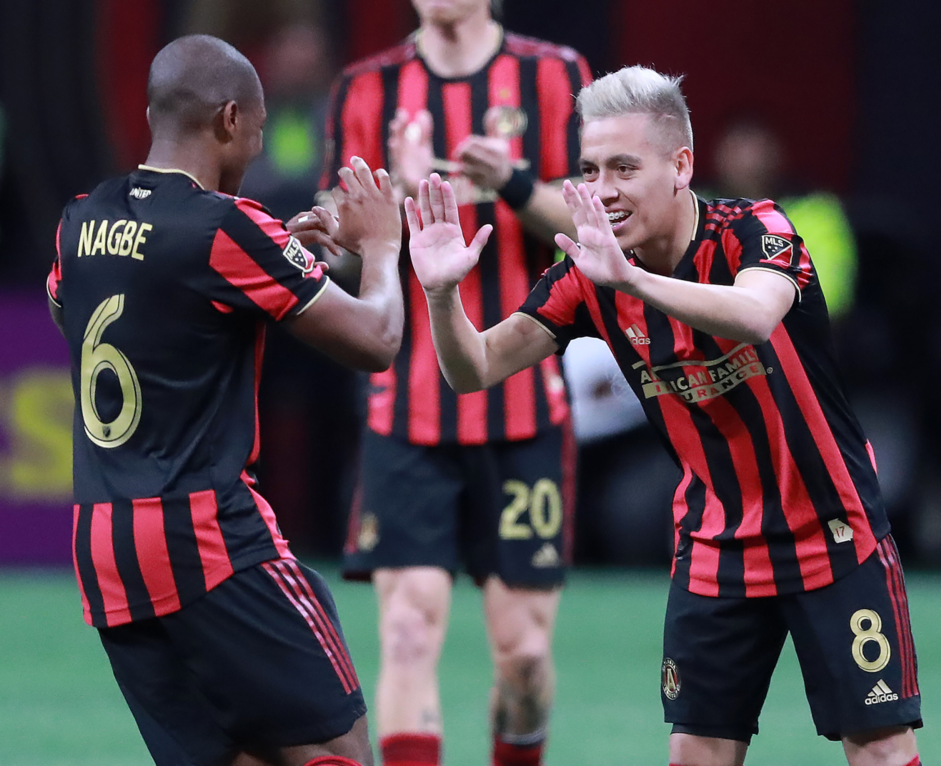 March 17, 2019 Atlanta: Atlanta United midfielder Ezequiel Barco (right) gets five from Darlington Nagbe after heading the ball into the net past Philadelphia Union defender Haris Medunjanin to tie it up 1-1 during the second half in a MLS soccer match that ended in a 1-1 draw on Sunday, March 17, 2019, in Atlanta. Curtis Compton/ccompton@ajc.com