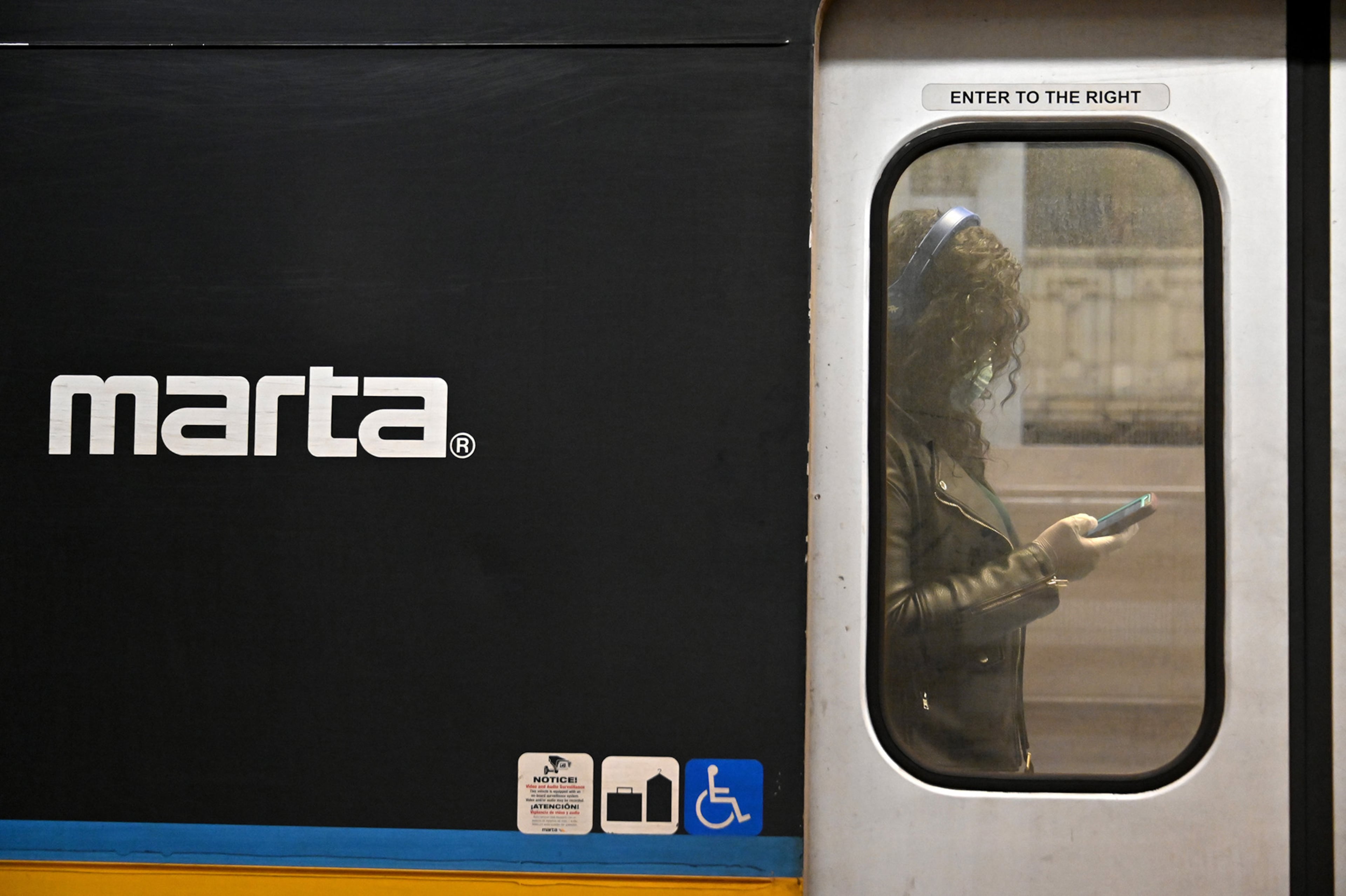 March12, 2020 Atlanta - A Marta customer wearing a mask stands inside a train during an afternoon rush hour at the Five Points MARTA station on Thursday, March 11, 2020. (Hyosub Shin / Hyosub.Shin@ajc.com)