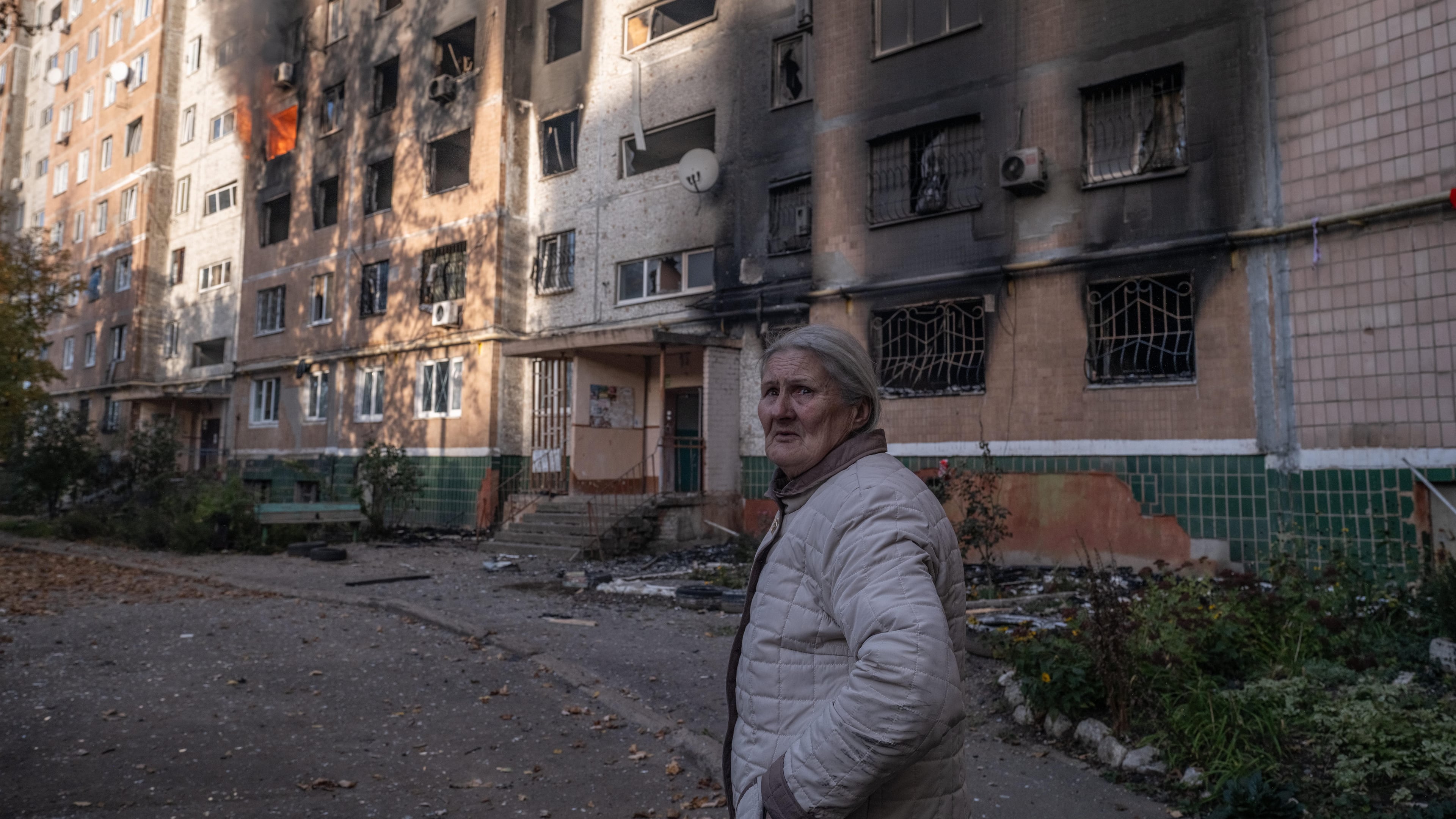 In this photo provided by Ukraine's 93rd Kholodnyi Yar Separate Mechanized Brigade press service and taken Tuesday, Oct. 27, 2026, a local resident leaves her damaged home after a Russian airstrike in Kramatorsk, Donetsk region, Ukraine. (Iryna Rybakova/Ukraine's 93rd Mechanized Brigade via AP)