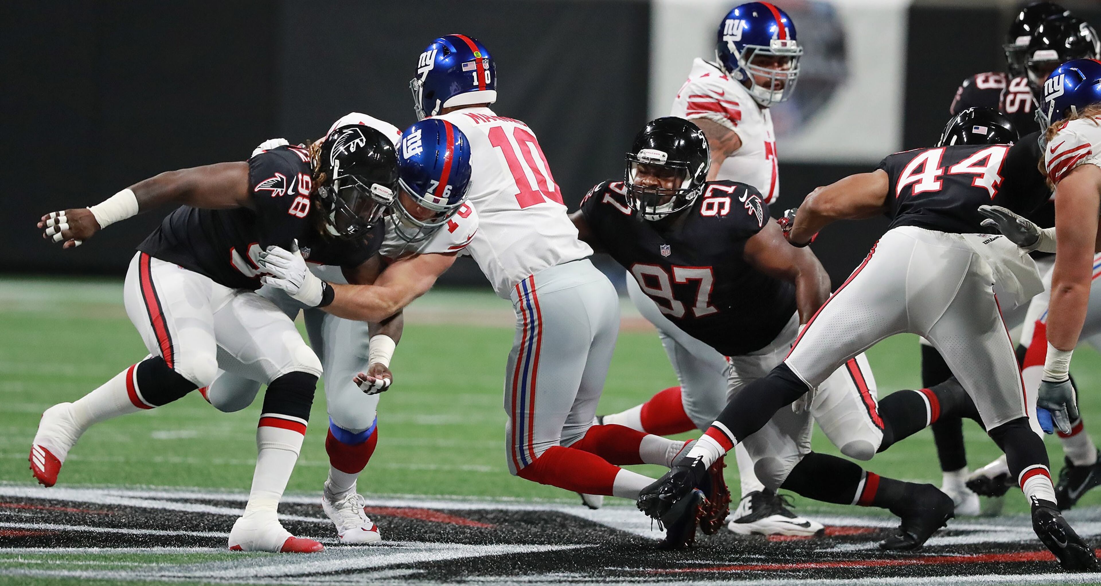 October 22, 2018 Atlanta: Atlanta Falcons defensive tackle Grady Jarrett sacks New York Giants Eli Manning during the first quarter with Takkarist McKinley (left) applying pressure in a NFL football game on Monday, Oct 22, 2018, in Atlanta. Curtis Compton/ccompton@ajc.com