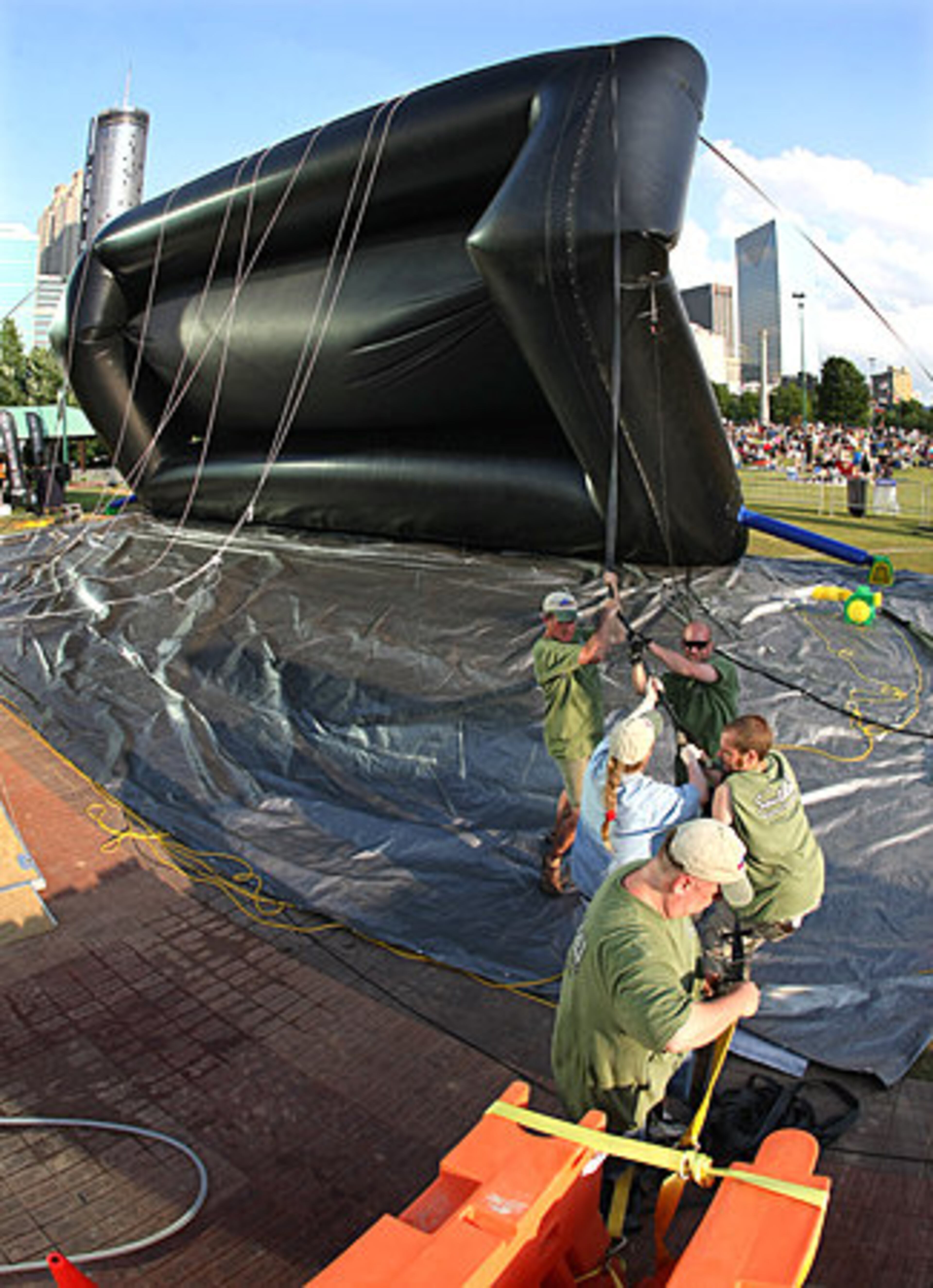 Workers continue to upright the screen.