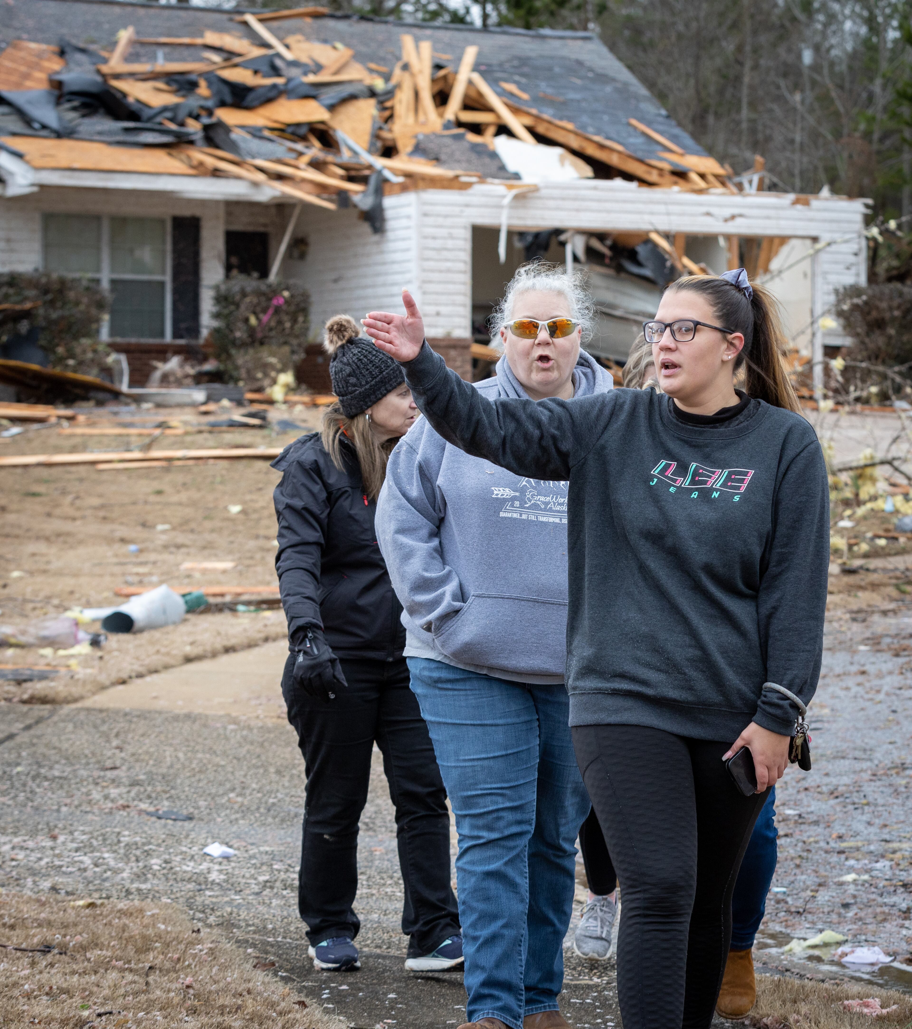 Clearview Elementary School teachers who volunteered to help people with tornado-damaged homes walk around the Lexington Park neighborhood in LaGrange Friday, Jan 13, 2023. (Steve Schaefer/steve.schaefer@ajc.com)