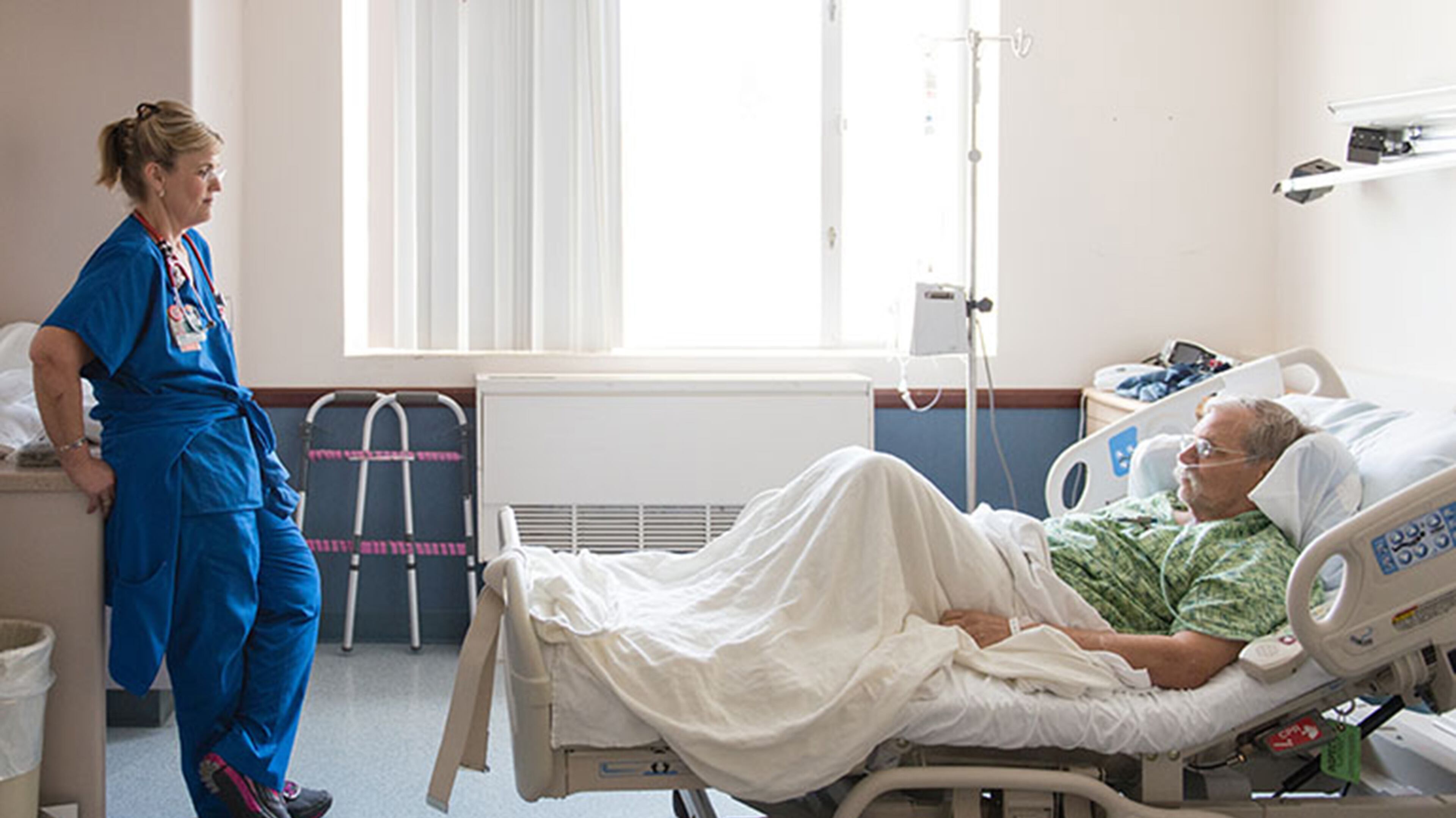 Dawn Nagel checks up on Scott Steffens. Heidi de Marco/Kaiser Health News/TNS