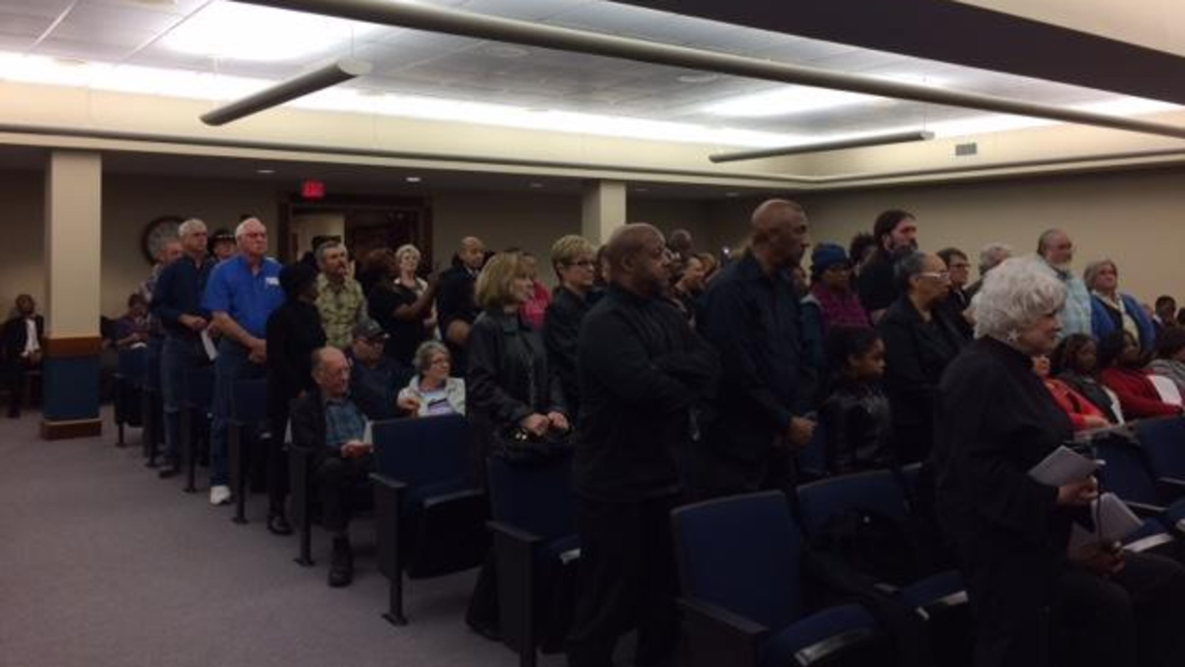 Clayton residents stand during a March 2017 meeting in protest of a County Commission decision a month earlier that stopped CCTV 23 from televising public comments.