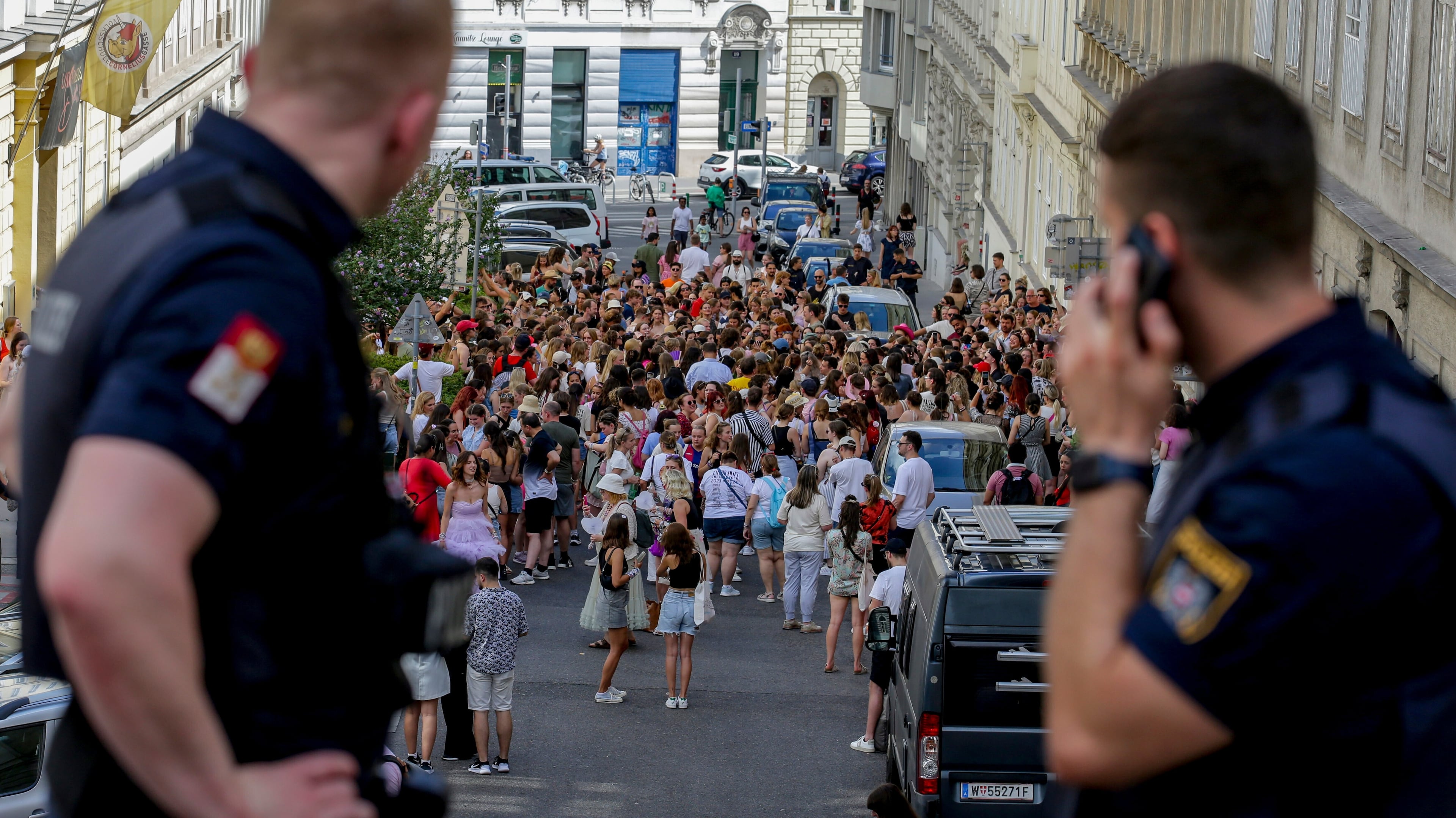 FILE - Austrian police officers watch a gathering of Taylor Swift fans in the city centre in Vienna on Aug. 8, 2024. (AP Photo/Heinz-Peter Bader, File)