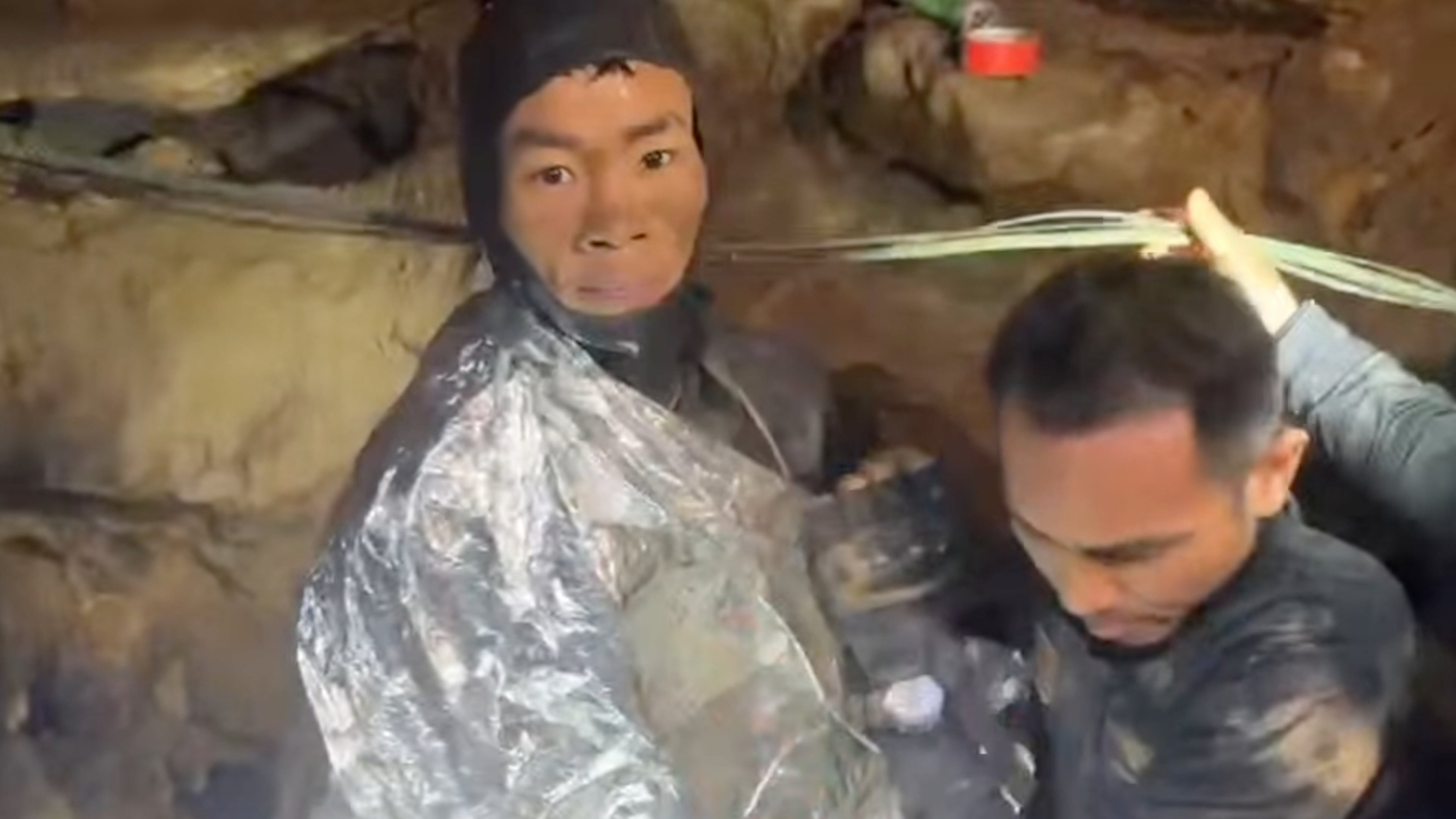 This video grab provided by Metta Tham Rescue Kalasin, shows rescuers evacuating the first of five villagers, left, who had been trapped in a cave in Xaisomboun province, Laos, Friday, May 29, 2026. (Metta Tham Rescue Kalasin via AP)