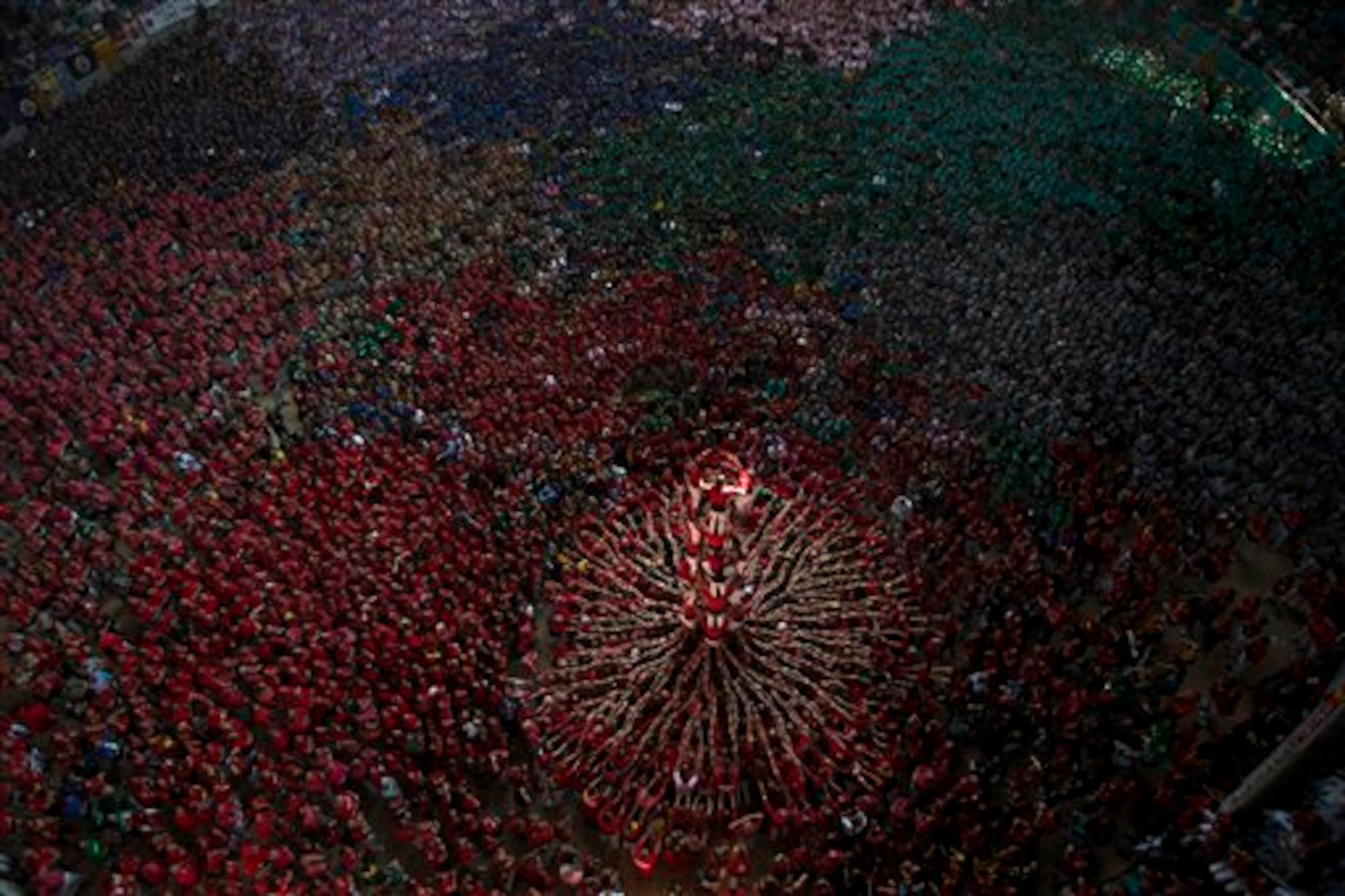 Members of the Castellers Joves Xiquets de Valls try to complete their human tower during the 25th Human Tower Competition in Tarragona, Spain, on Sunday, Oct. 5, 2014. The tradition of building human towers or �castells� dates back to the 18th century and takes place during festivals in Catalonia, where �colles� or teams compete to build the tallest and most complicated towers. The structure of the �castells� varies depending on their complexity. A �castell� is considered completely successful when it is loaded and unloaded without falling apart. The highest �castell� in history was a 10 floor structure with 3 people in each floor. In 2010 �castells� were declared by UNESCO one of the Masterpieces of the Oral and Intangible Heritage of Humanity. (AP Photo/Emilio Morenatti)
