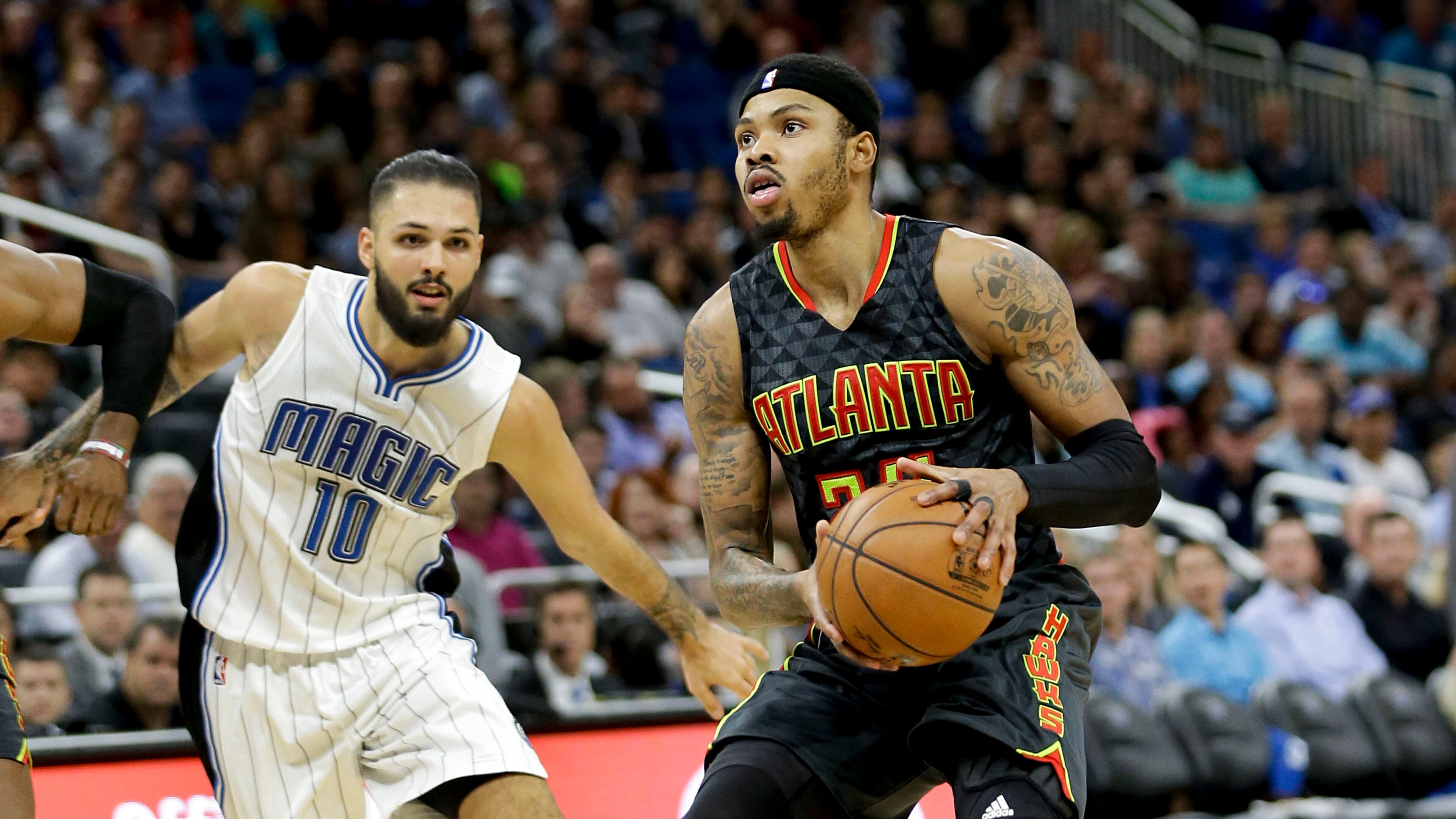 Atlanta Hawks’ Kent Bazemore, right, looks for a shot as he gets past Orlando Magic’s Evan Fournier (10) during the second half of an NBA basketball game, Wednesday, Jan. 4, 2017, in Orlando, Fla. Atlanta won 111-92. (AP Photo/John Raoux)