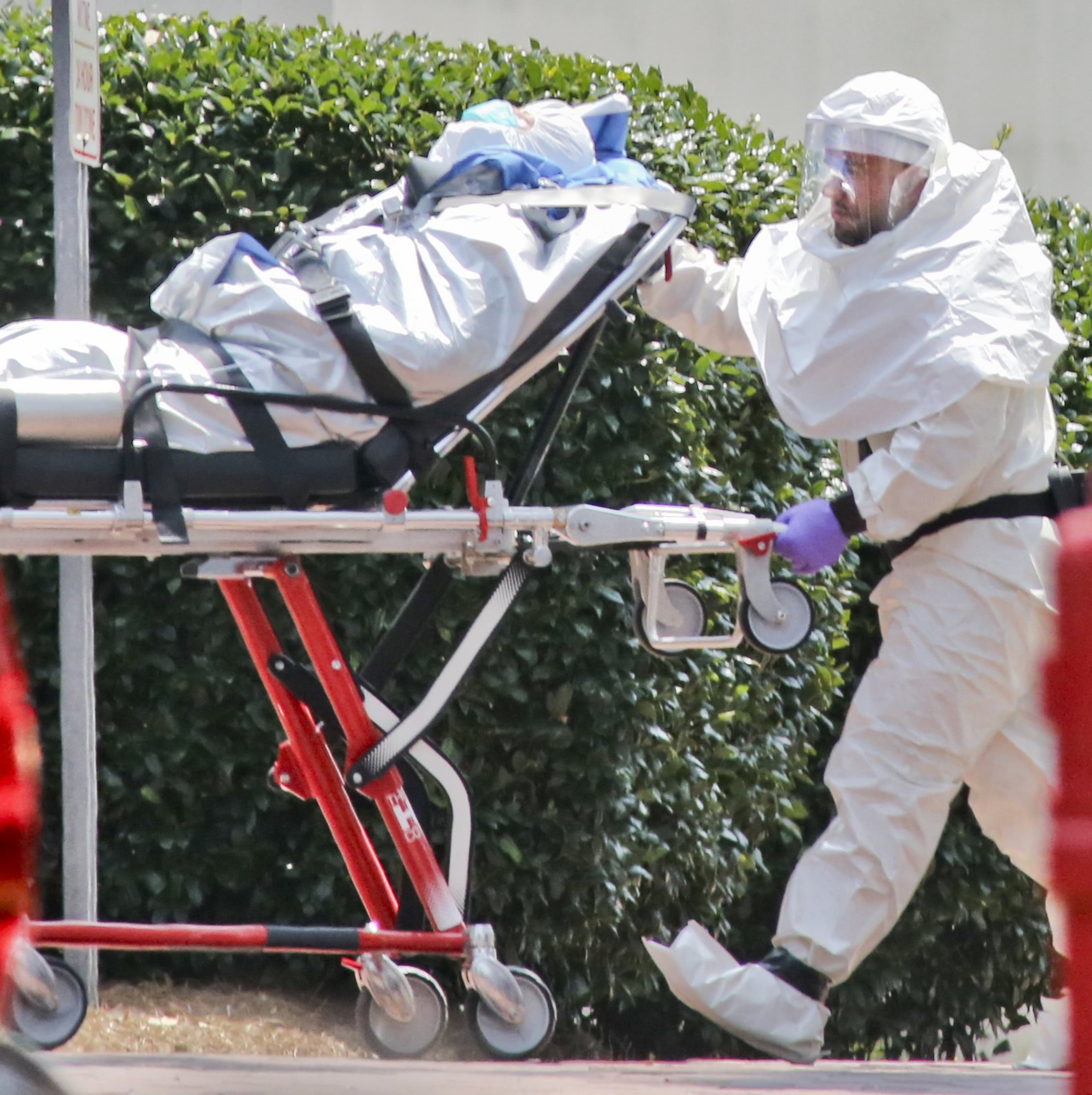 In this file photo, medical workers roll patient Nancy Writebol into Emory University Hospital. The second American aid worker infected with Ebola arrived Aug. 5, 2014, in Atlanta. Writebol arrived in a chartered jet at Dobbins Air Reserve Base and was then taken in an ambulance to Emory University Hospital. She was rolled into the hospital by suited medical personnel. Three days earlier, Dr. Kent Brantly, also diagnosed with the virus, arrived at Emory University Hospital and walked from the ambulance. Both recovered. JOHN SPINK / JSPINK@AJC.COM