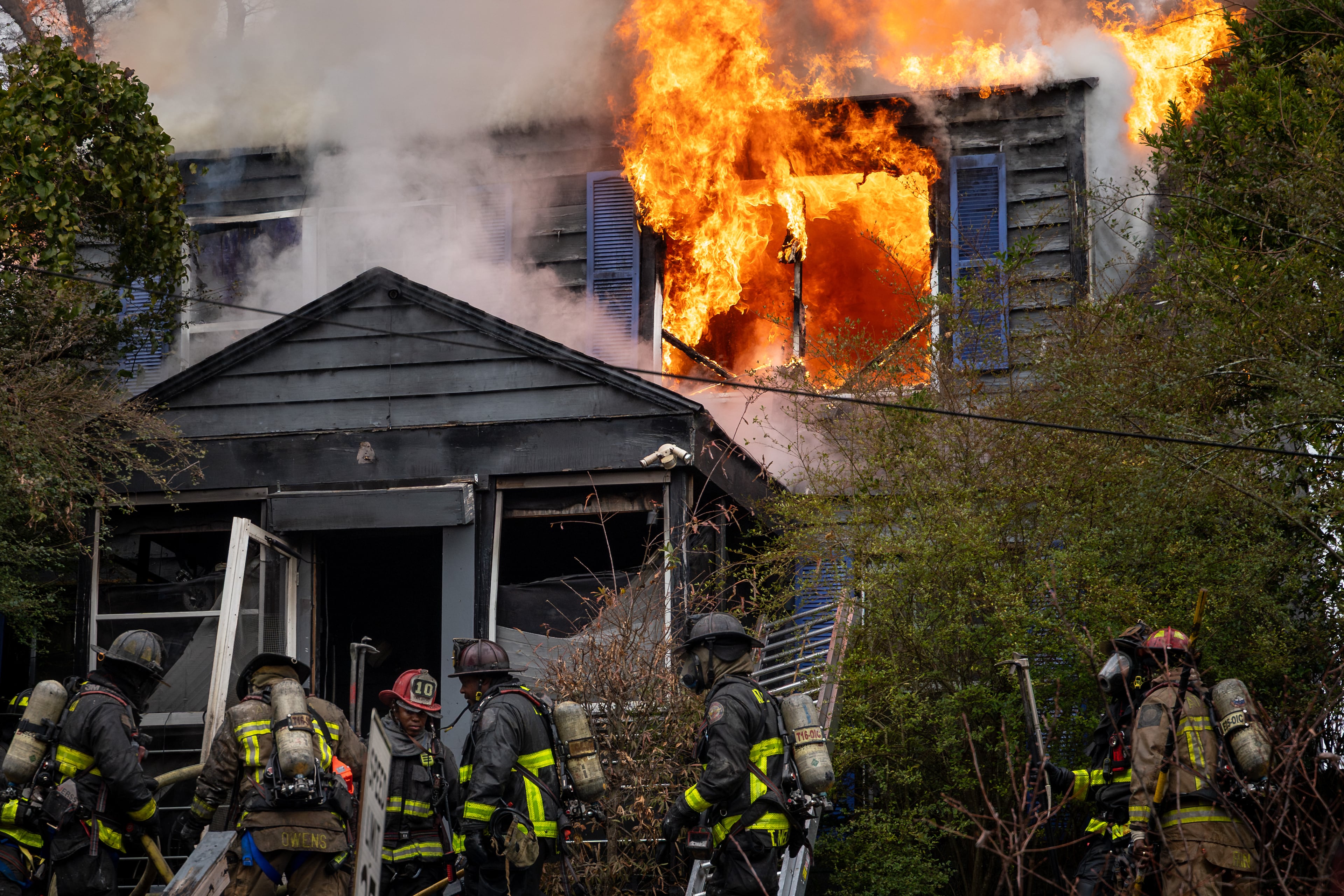 Atlanta firefighters battle a blaze at a home on Fair Street in southwest Atlanta late last year. The former head of the city's firefighter union is suing the city, the mayor and fire chief, alleging retaliation against him for advocating for better working conditions. (Ben Hendren for the AJC)
