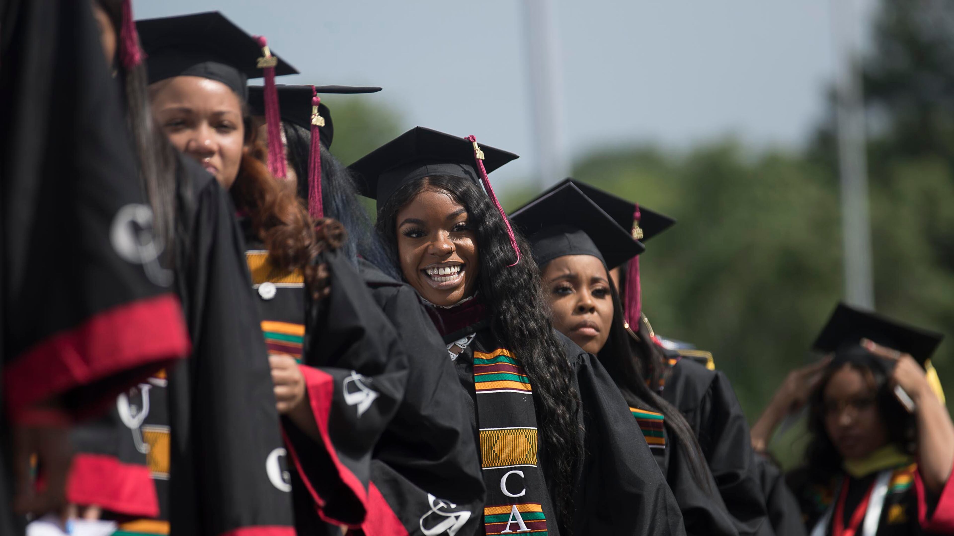 Proud graduates line up on stage before receiving their degree during Clark Atlanta University's 30th annual commencement ceremony at Panther Stadium in Atlanta, Monday, May 20, 2019. Its enrollment is about 4,000 students, the largest of any historically black college and university in Atlanta. (Alyssa Pointer/alyssa.pointer@ajc.com)