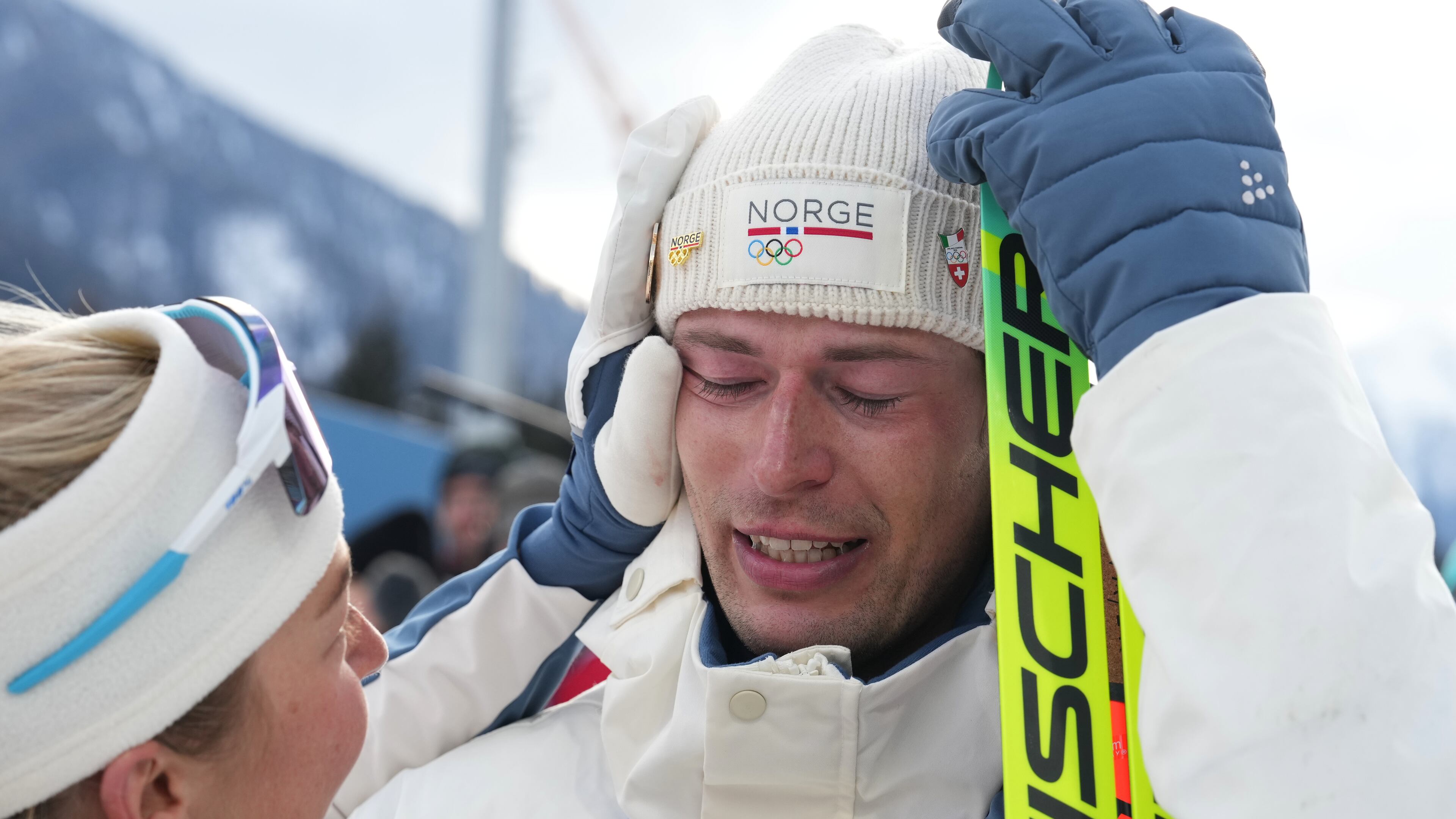 ADDS NAME OF TEAMMATE - Sturla Holm Laegreid, of Norway, reacts after he won bronze as teammate Ingrid Landmark Tandrevold comforts him after the men's 20-kilometer individual biathlon race at the 2026 Winter Olympics in Anterselva, Italy, Tuesday, Feb. 10, 2026. (AP Photo/Andrew Medichini)