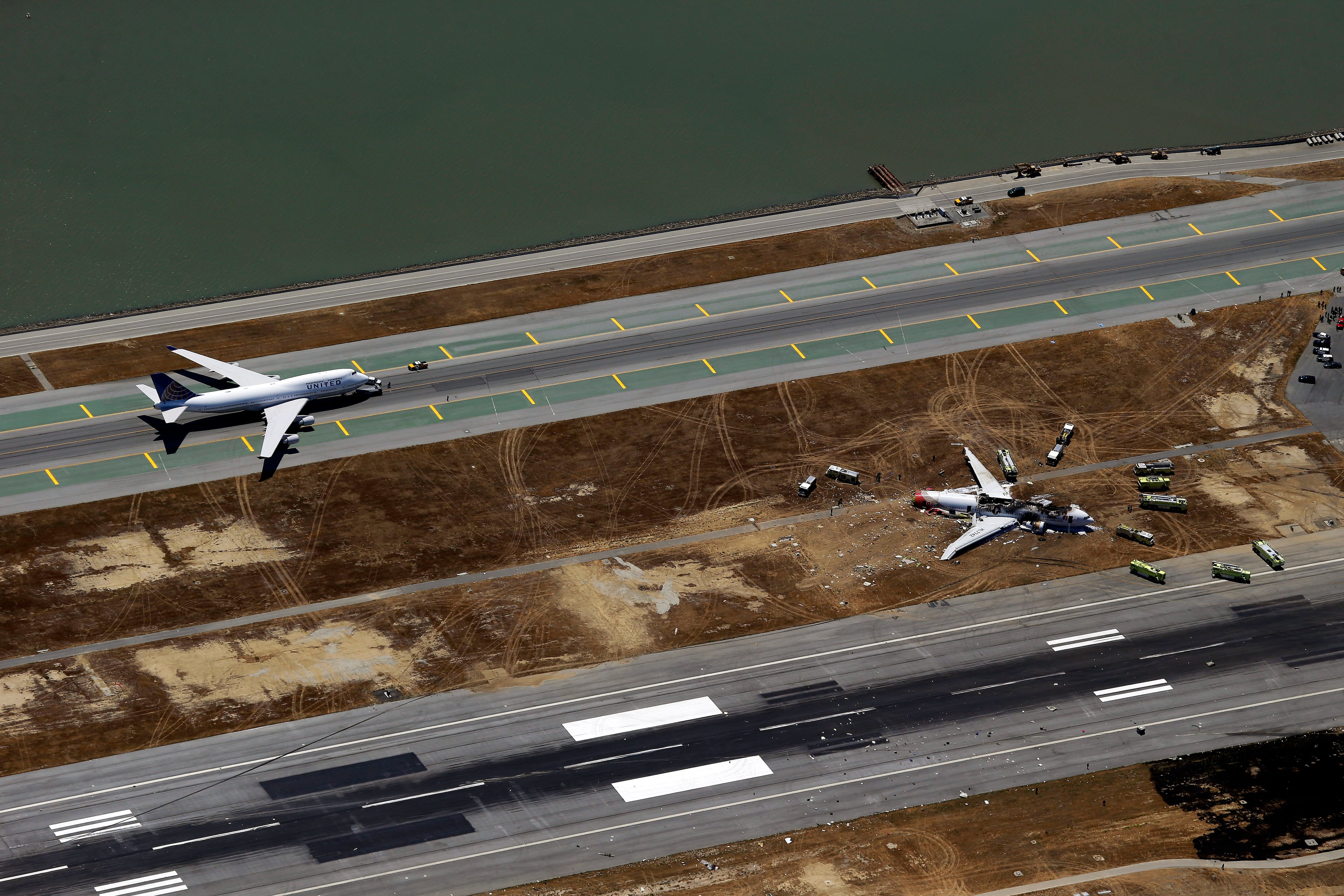 This aerial photo shows the crash site of Asiana Flight 214 at the San Francisco International Airport in San Francisco, Saturday, July 6, 2013. (AP Photo/Marcio Jose Sanchez)