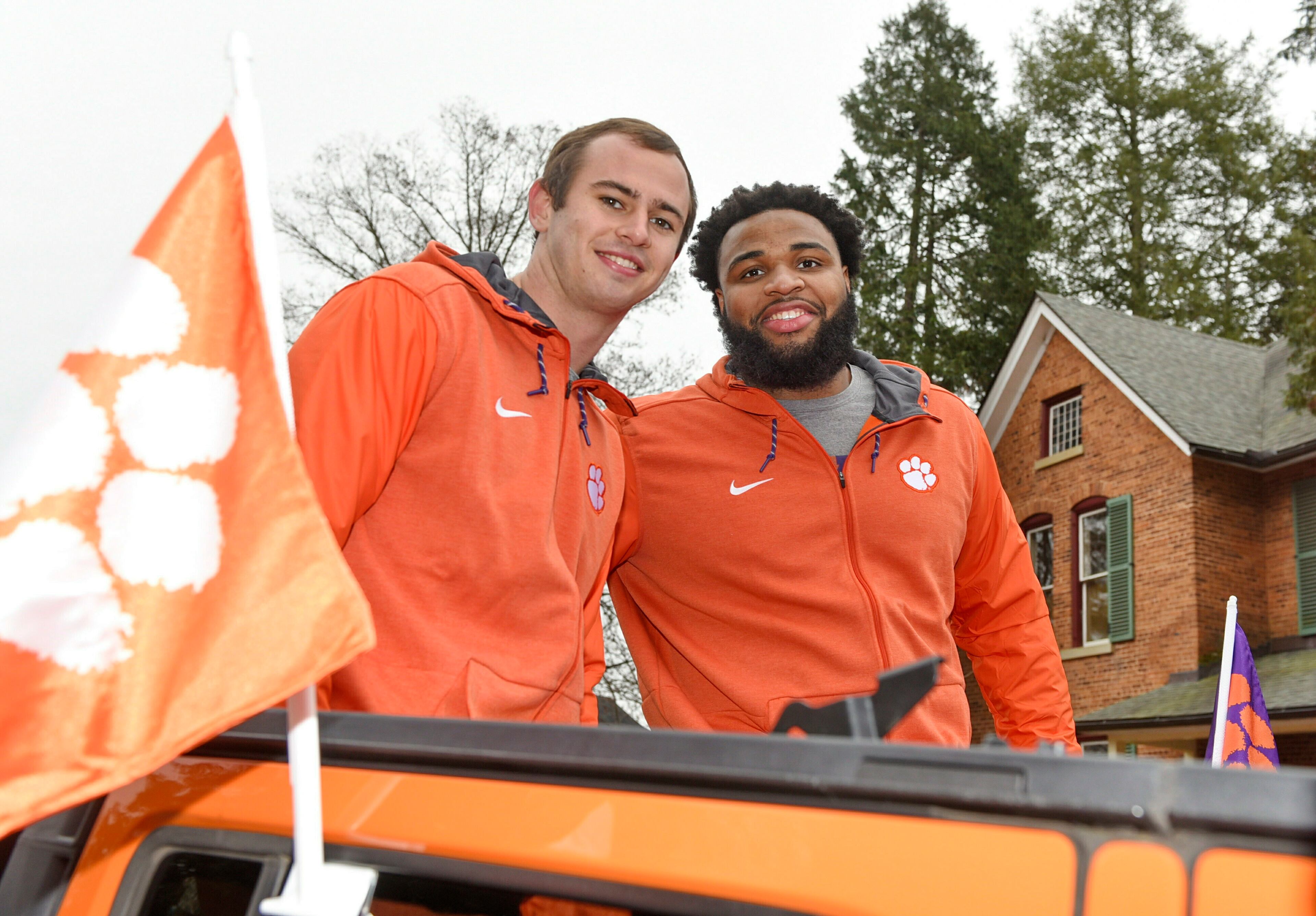 Hunter Renfrow, left, and Christian Wilkins ride in the parade held for Clemson, Saturday, Jan. 12, 2019, in Clemson, S.C., after the Tigers defeated Alabama 44-16 in the College Football Playoff championship game Monday Jan. 7. (AP Photo/Richard Shiro)