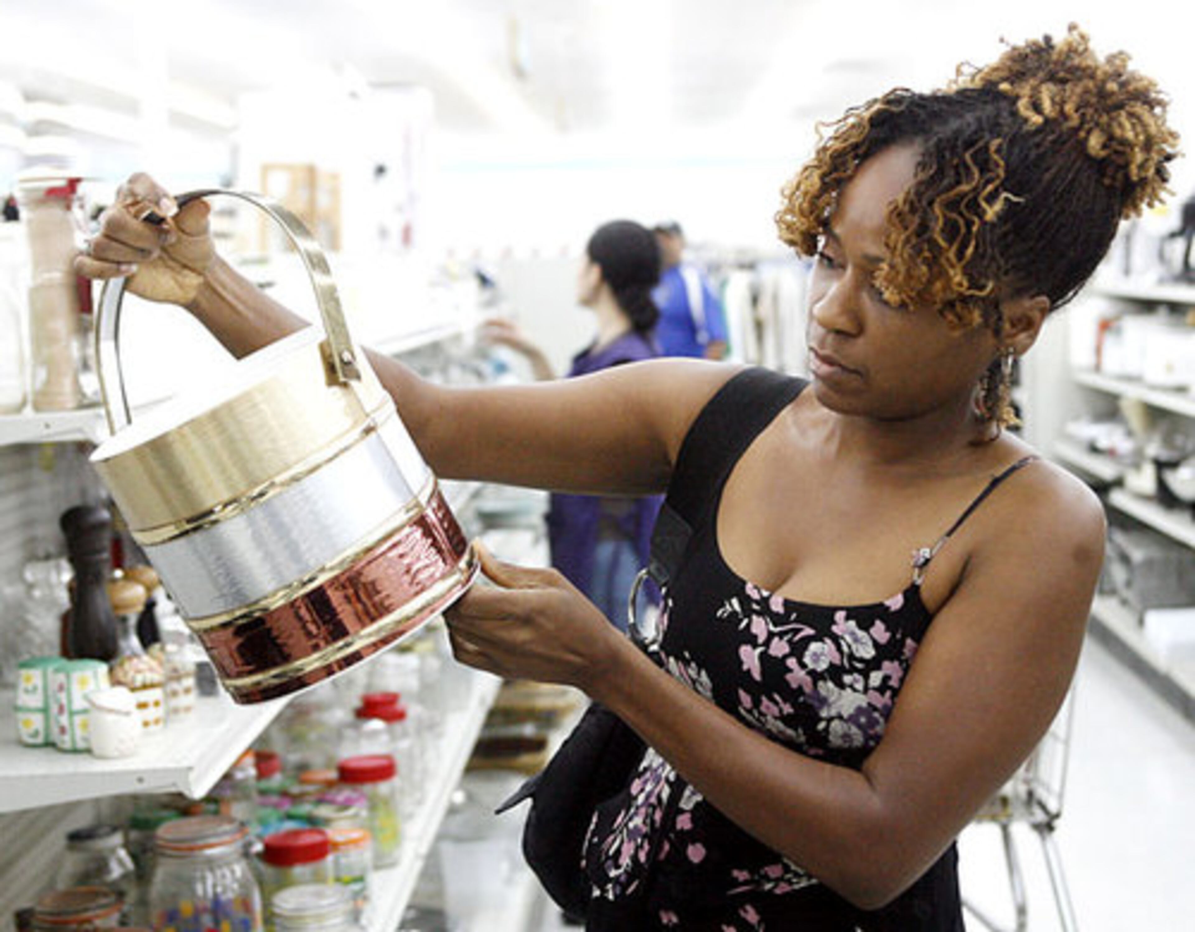 Taiysha Brown looks over an ice bucket at Value Village.