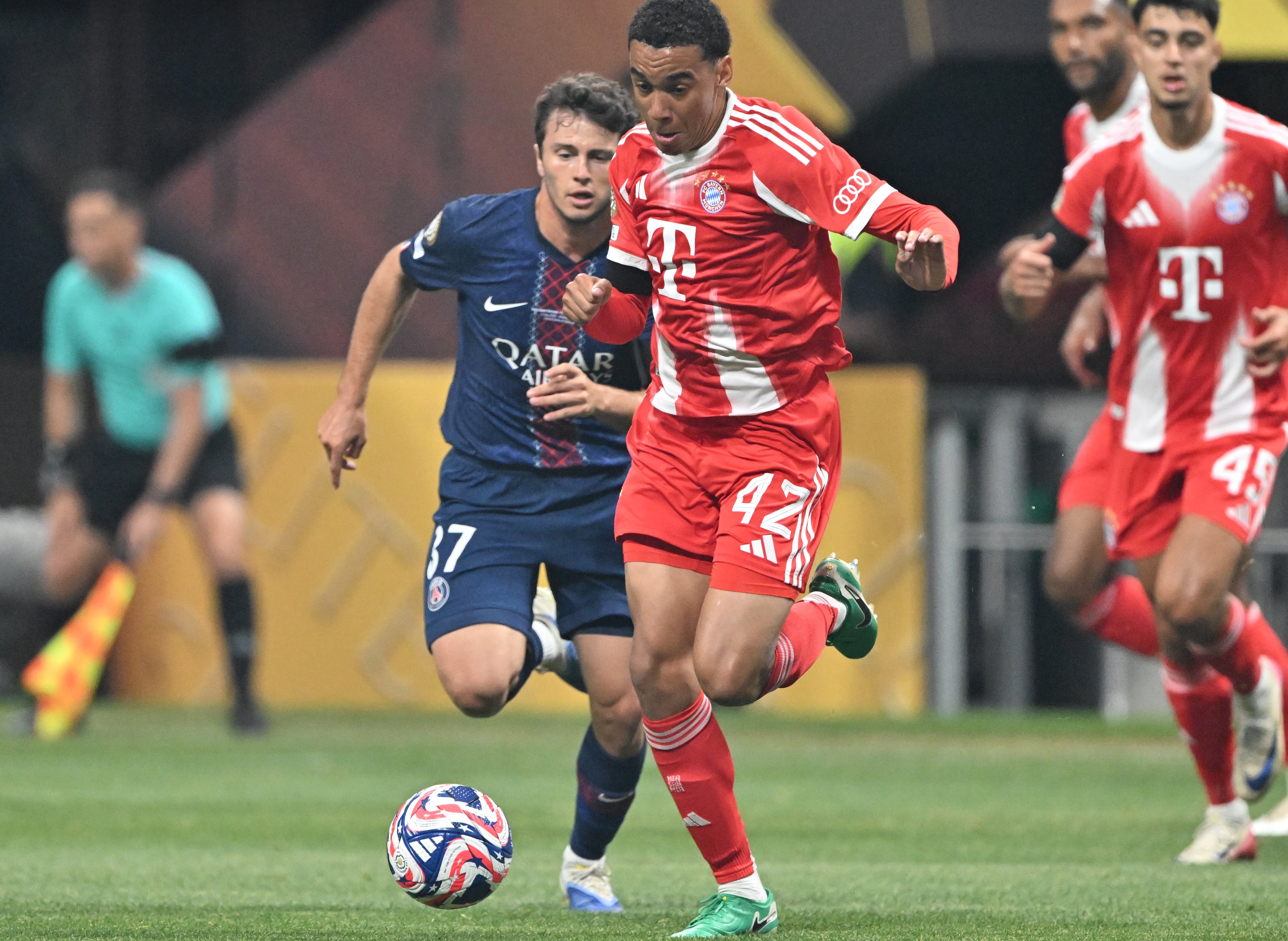 Bayern Munich midfielder Jamal Musiala (center) gets past Paris Saint-Germain midfielder João Neves (left) during the first half of the Club World Cup quarterfinals match at Mercedes-Benz Stadium on Saturday, July 5, 2025, in Atlanta. (Hyosub Shin/AJC)