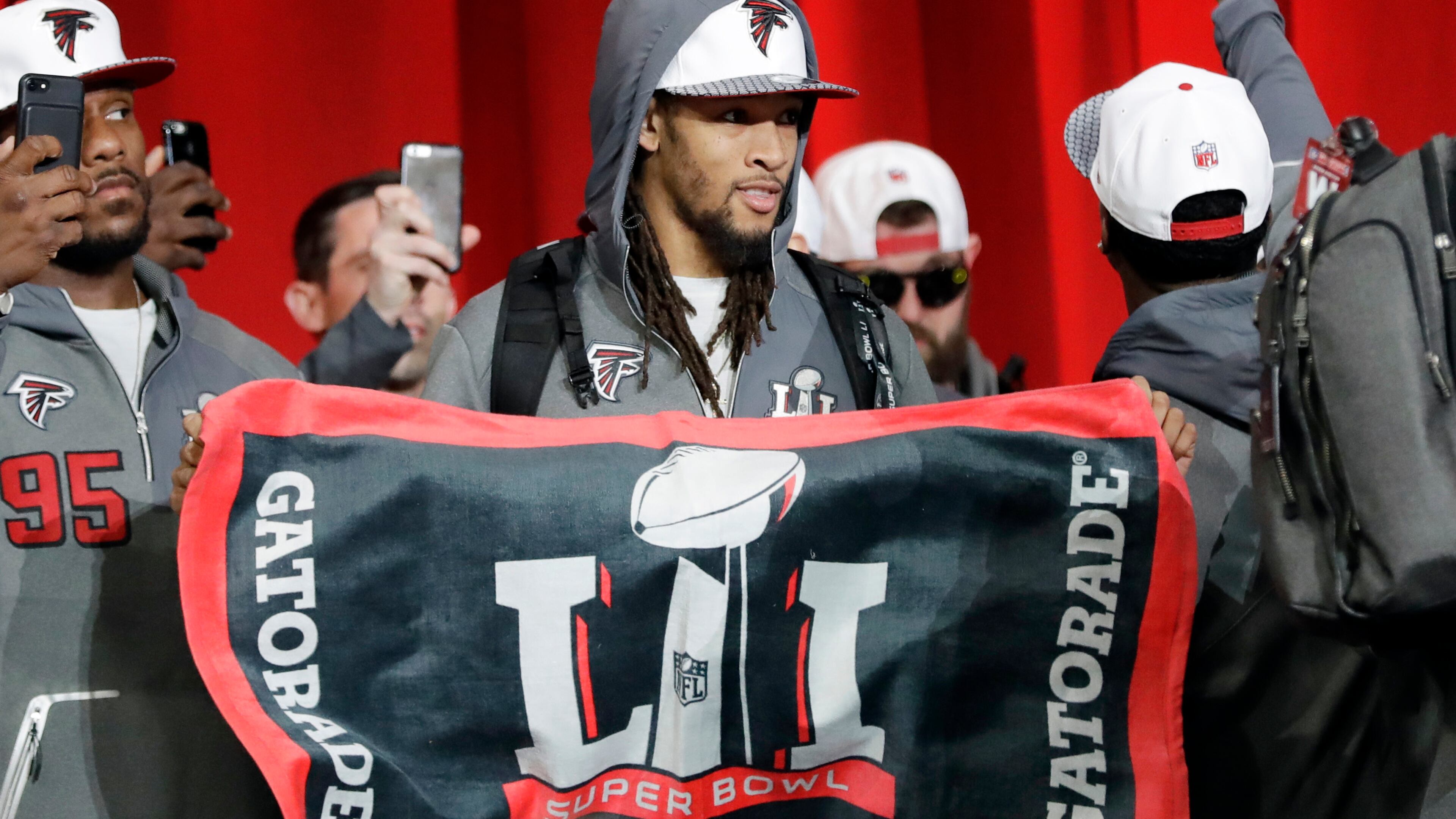 Atlanta Falcons' Jalen Collins holds a flag during opening night for the NFL Super Bowl 51 football game at Minute Maid Park Monday, Jan. 30, 2017, in Houston. (AP Photo/David J. Phillip)