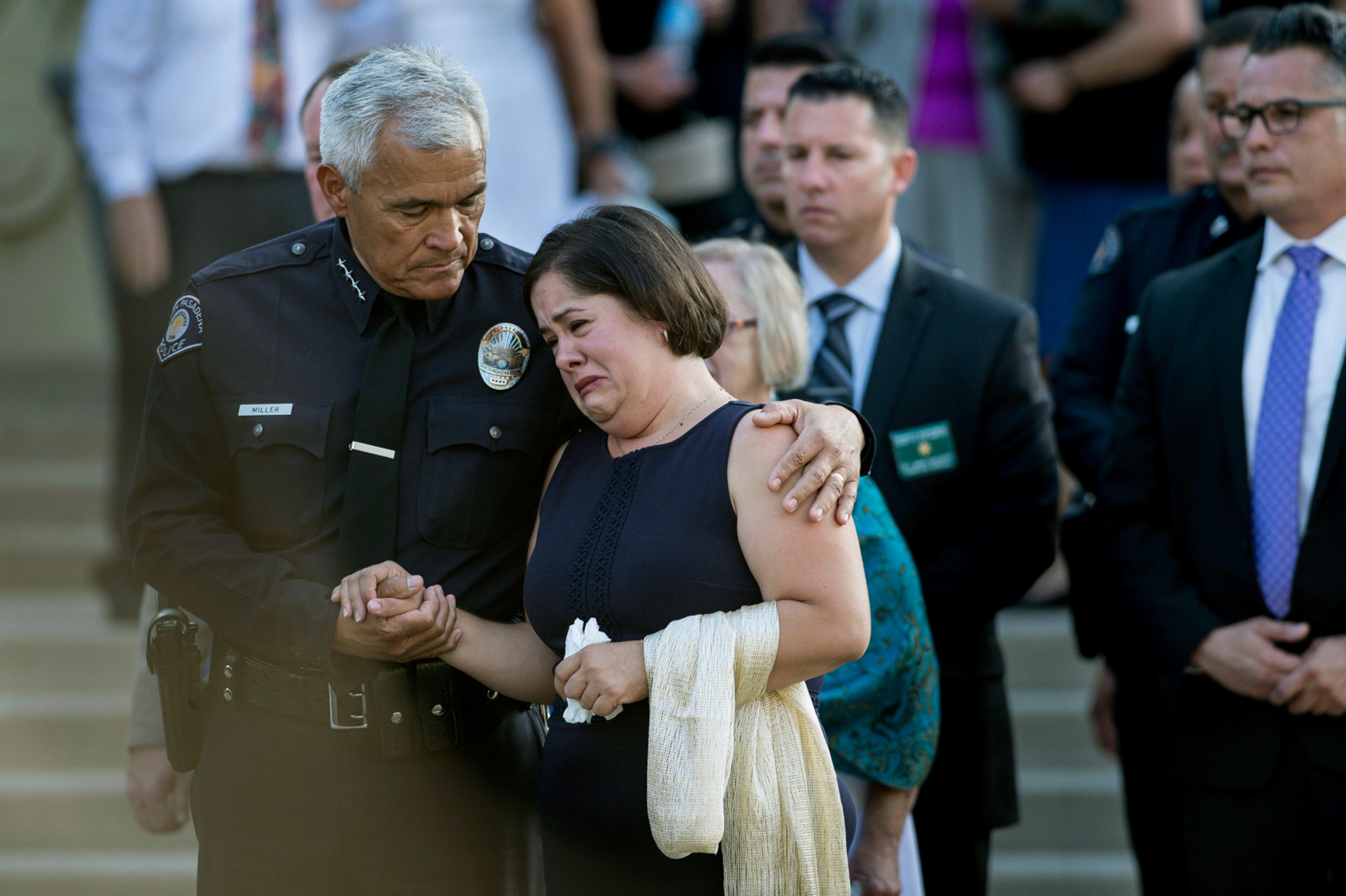 South Pasadena Police Chief Art Miller comforts Ana Estevez as they watch her son's coffin leave Holy Family Roman Catholic Church in South Pasadena, Calif., on Tuesday, July 18, 2017. A funeral was held Tuesday for 5-year-old Aramazd Andressian Jr. whose father is charged with killing him after a trip to Disneyland. (Sarah Reingewirtz /Los Angeles Daily News via AP)