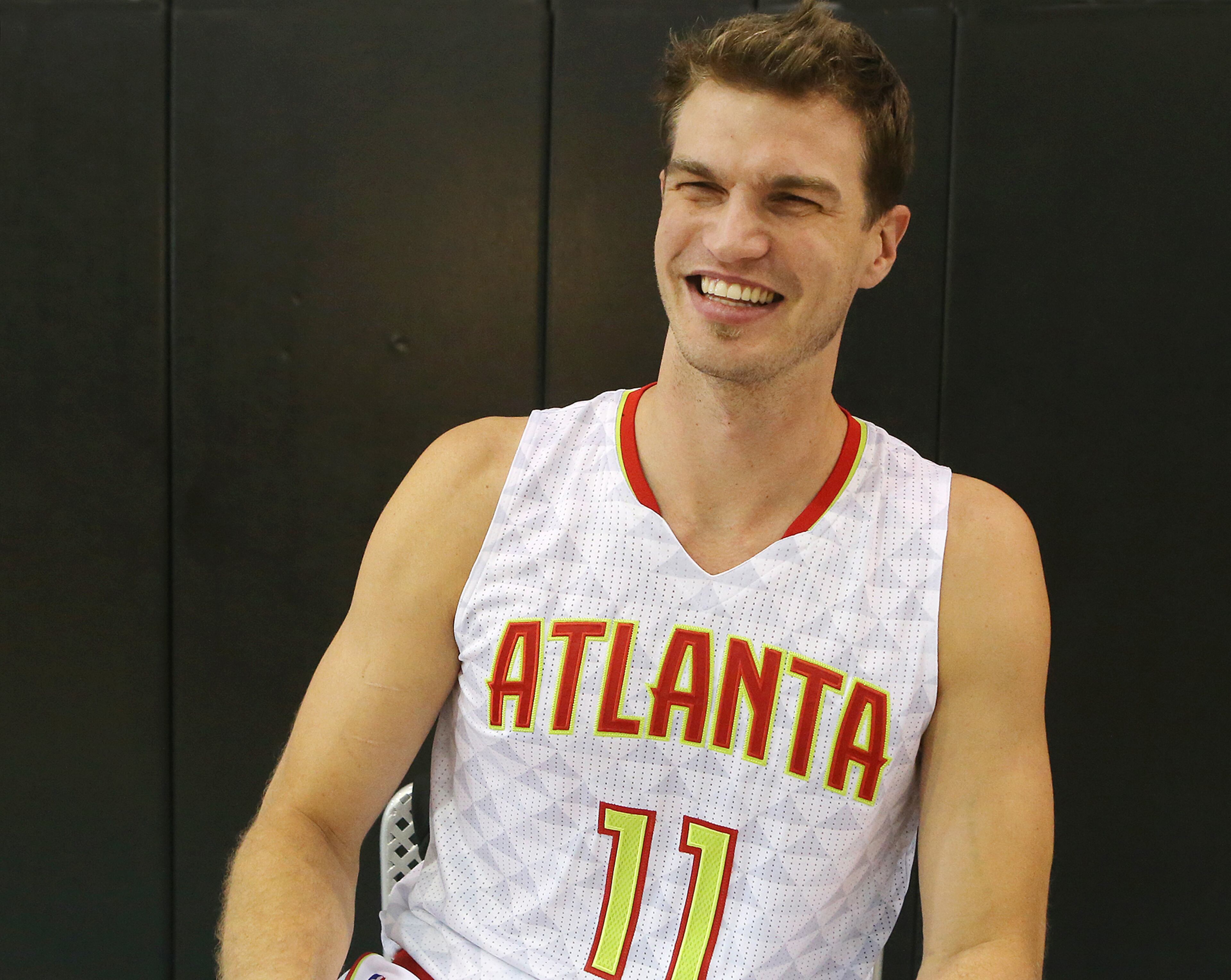 Hawks center Tiago Splitter breaks into laughter during an interview on the team's annual Media Day at the Philips Arena Practice Court on Monday, Sept. 28, 2015, in Atlanta.