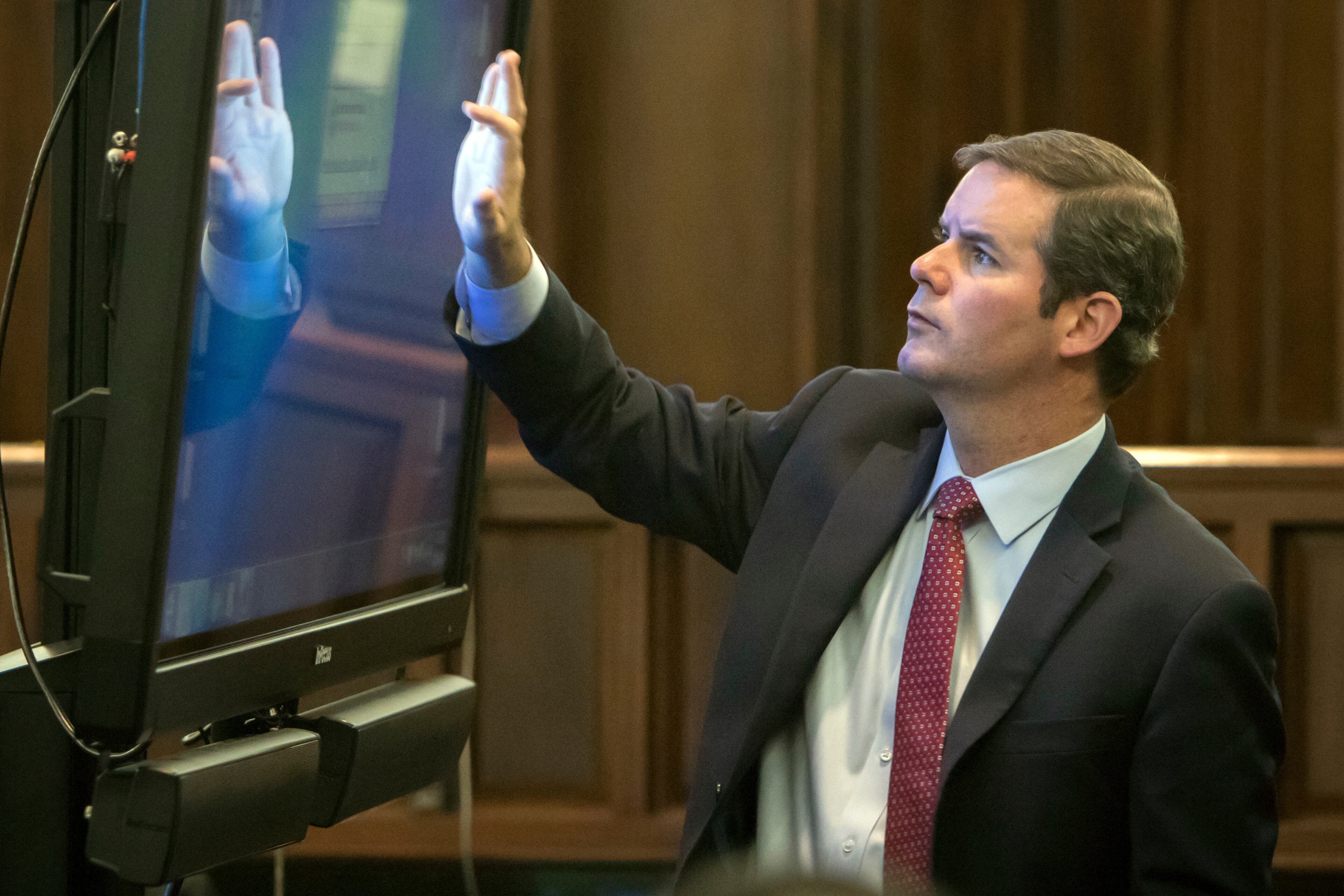 Cobb County Senior Assistant District Attorney Chuck Boring pulls up a surveillance video for the jury during the Justin Ross Harris murder trial, Thursday, Nov. 10, 2016, in Brunswick, Ga. (Stephen B. Morton/Atlanta Journal-Constitution via AP, Pool)