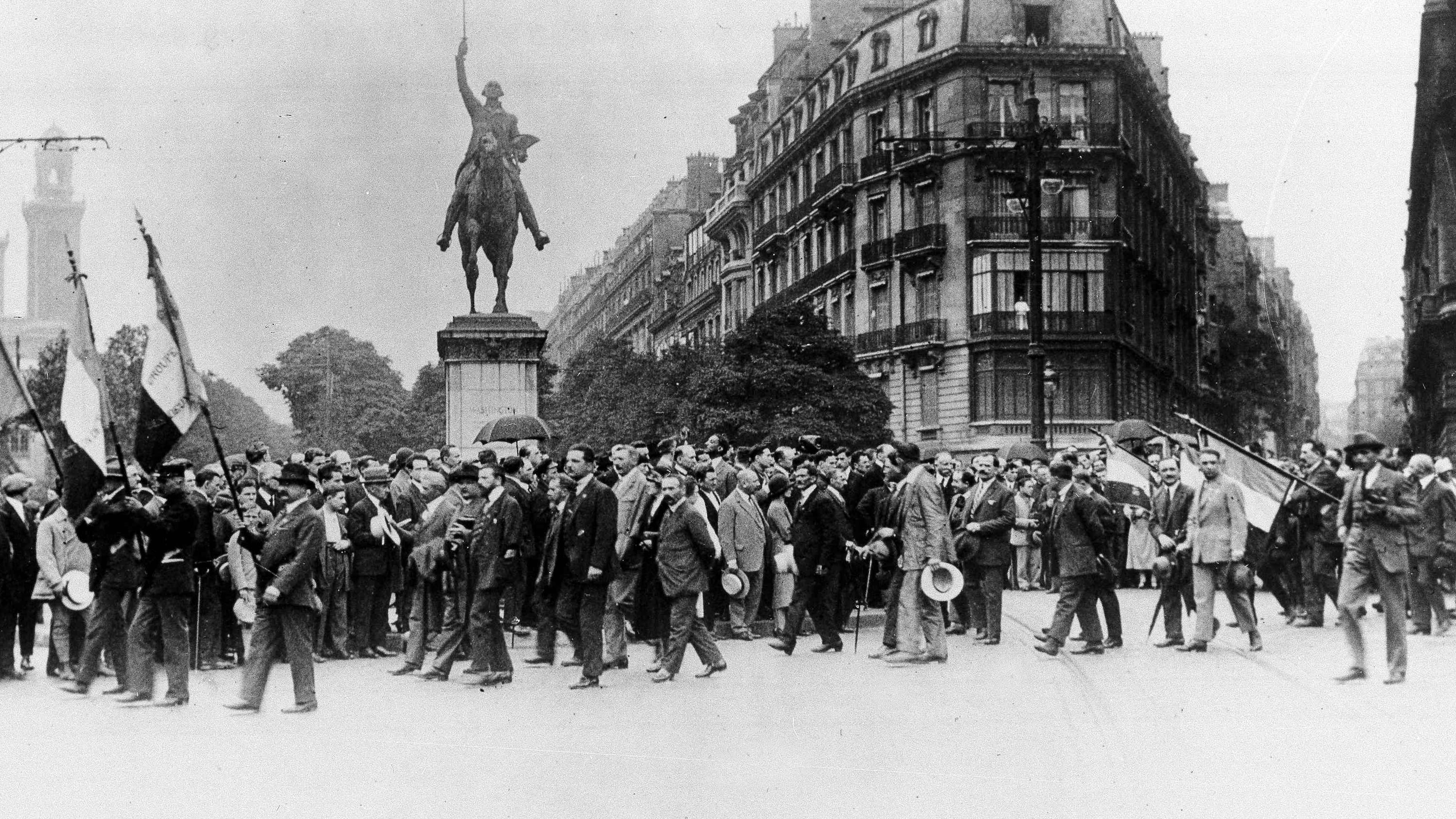 FILE - French war veterans march past the Washington Monument on the Place d'Iena in Paris, on July 19, 1926, in protest against the U.S. debt terms. (AP Photo, File)
