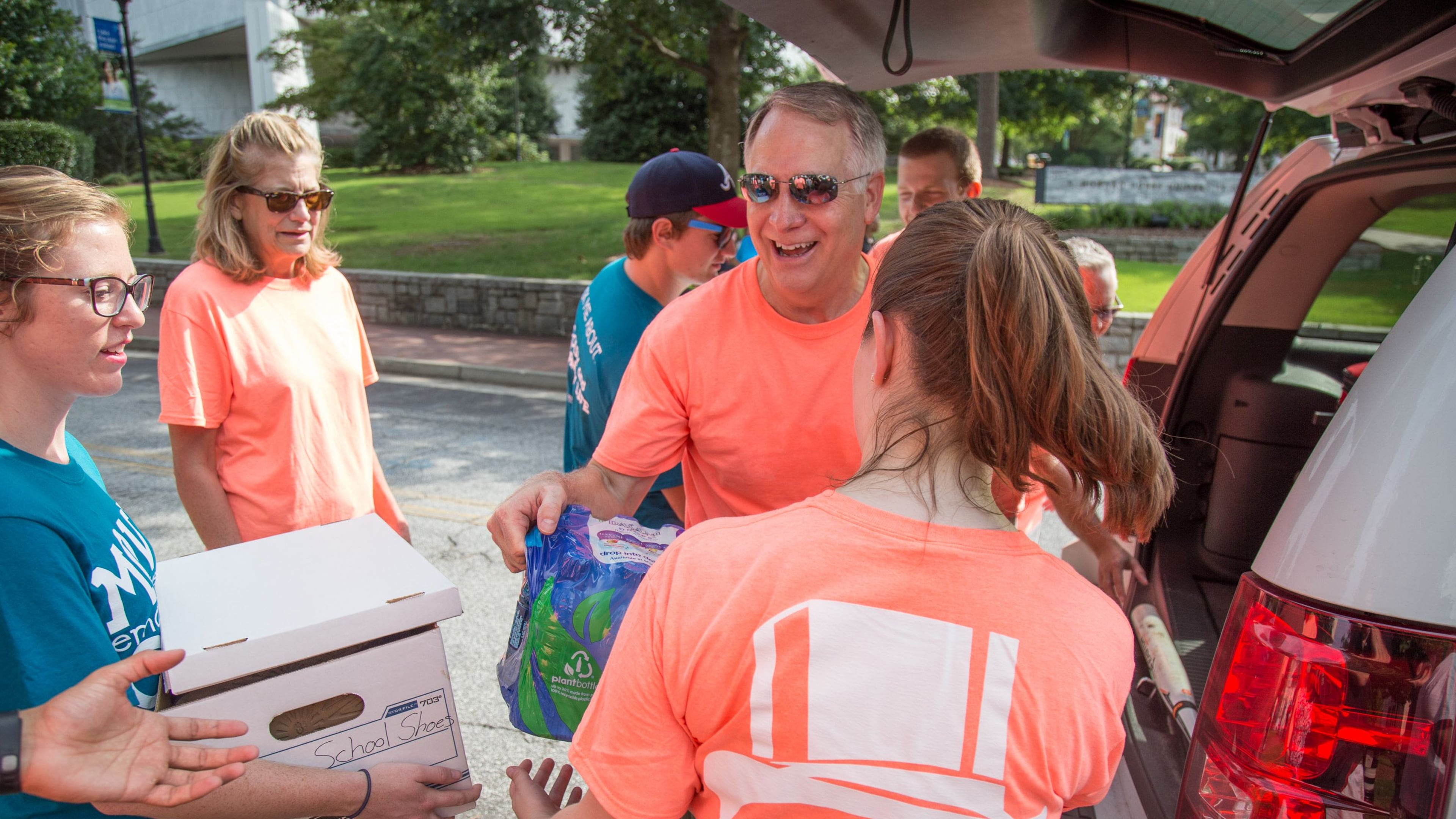 Emory President James Wagner (C) helps offload boxes during Emory’s move-in day in August. Wagner’s 2013 compensation was the highest among private college and university executives in Georgia, according to a survey released Sunday by The Chronicle of Higher Education. STEVE SCHAEFER / SPECIAL TO THE AJC