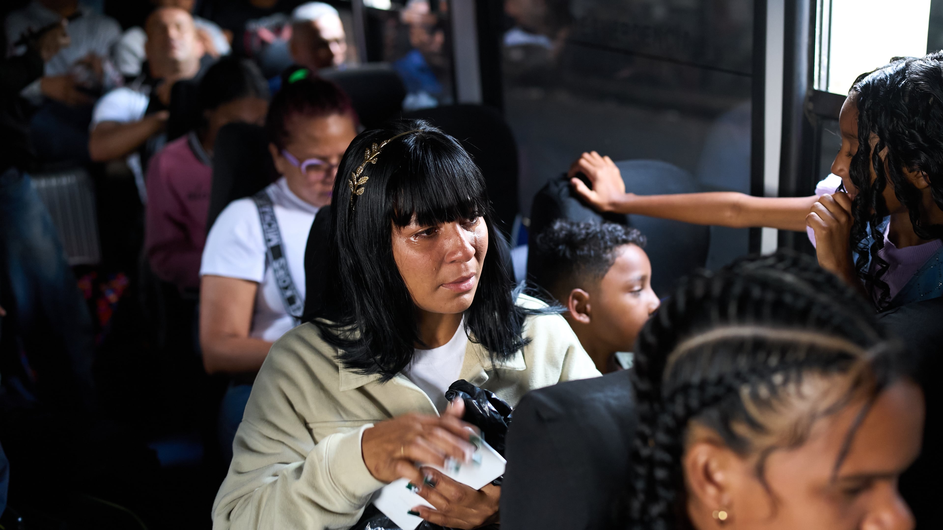Mileidy Mendoza and her children ride a bus from Caracas to visit her husband, Eric Diaz, imprisoned on political grounds at the Yare prison complex in San Francisco de Yare, Venezuela, Sunday, April 5, 2026. (AP Photo/Ariana Cubillos)