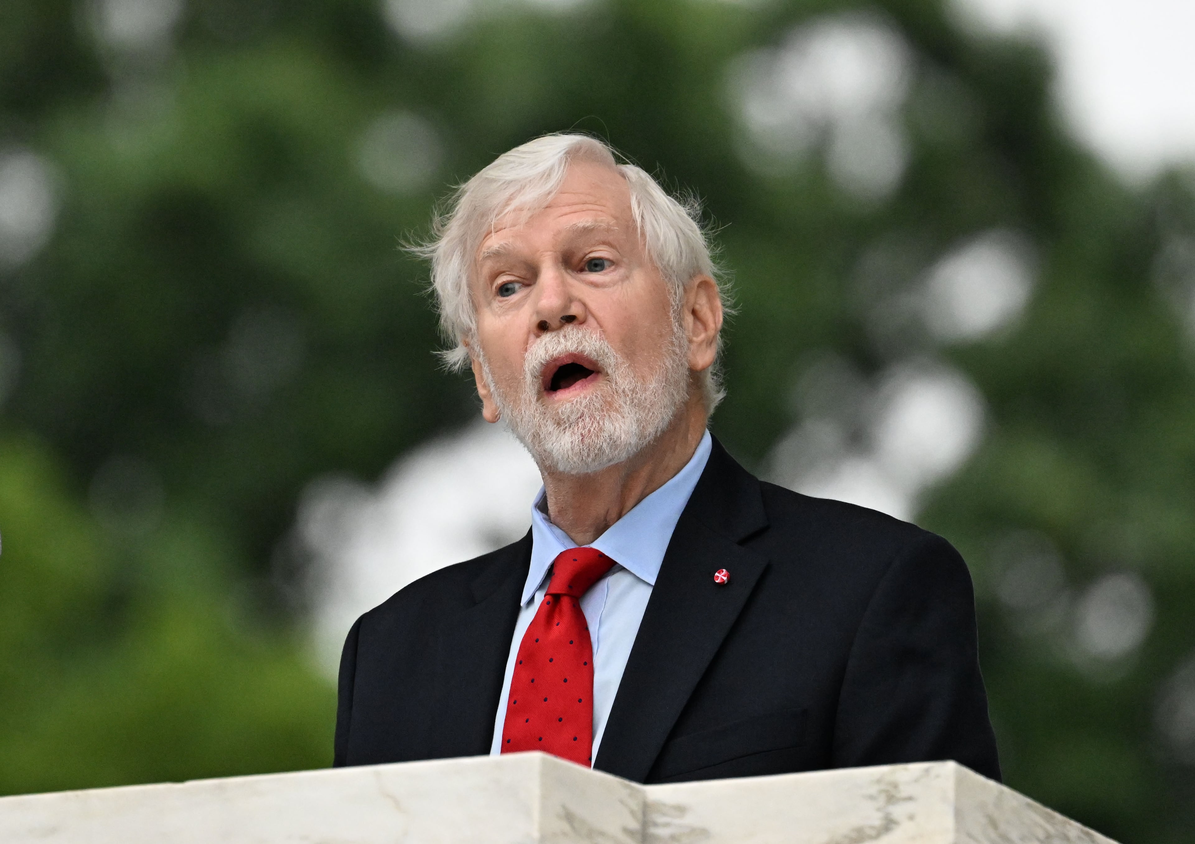 David Moore, with the National Memorial Day Association of Georgia, speaks during the Memorial Day Flag Placement event at Marietta National Cemetery on Saturday, May 23, 2026, in Marietta. Scouting groups in the community place more than 18,000 U.S. veteran grave flags at Marietta National Cemetery each year on the Saturday before Memorial Day, helping prepare for Monday’s ceremony. The long-running service project—organized with the National Memorial Day Association of Georgia—also gives youth and adults an opportunity to honor fallen service members and learn about their sacrifices and the area’s history. (Hyosub Shin/AJC)