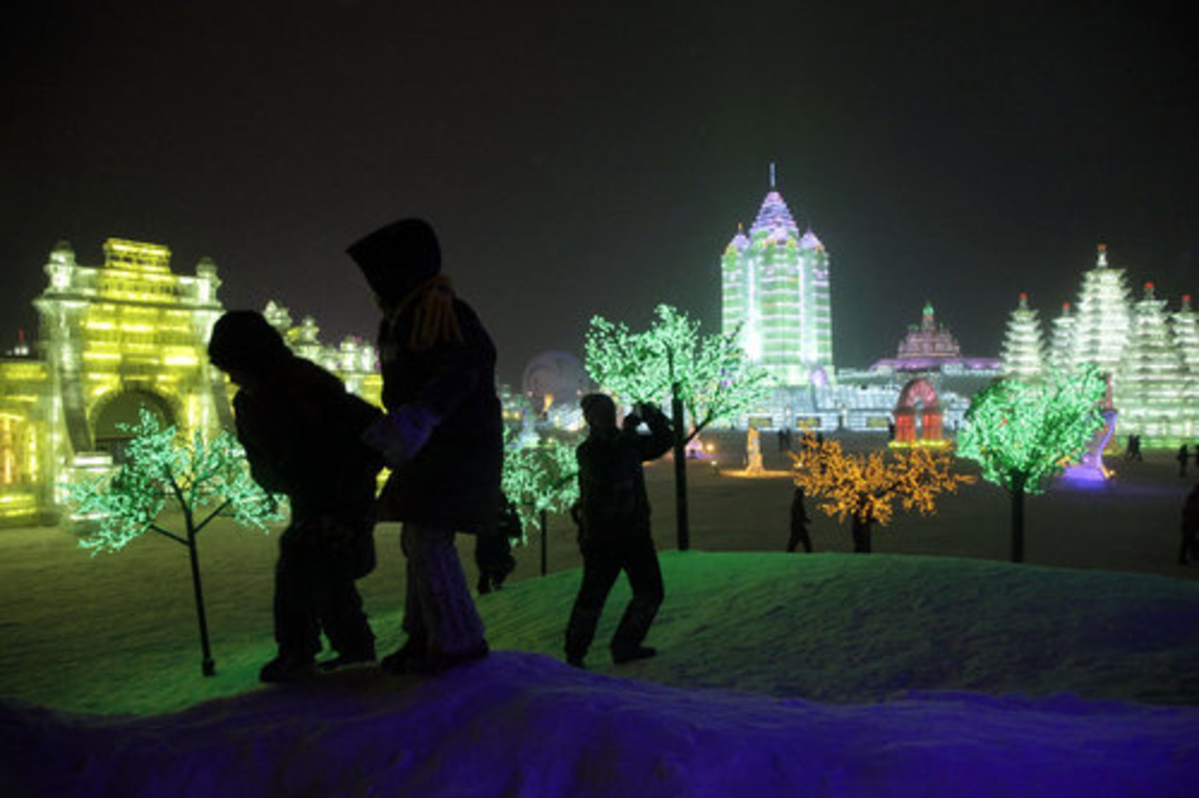 Visitors take photos of the illuminated delights at the Harbin International Ice and Snow festival. A recent cold spell in northern China has benefited the annual festival.
