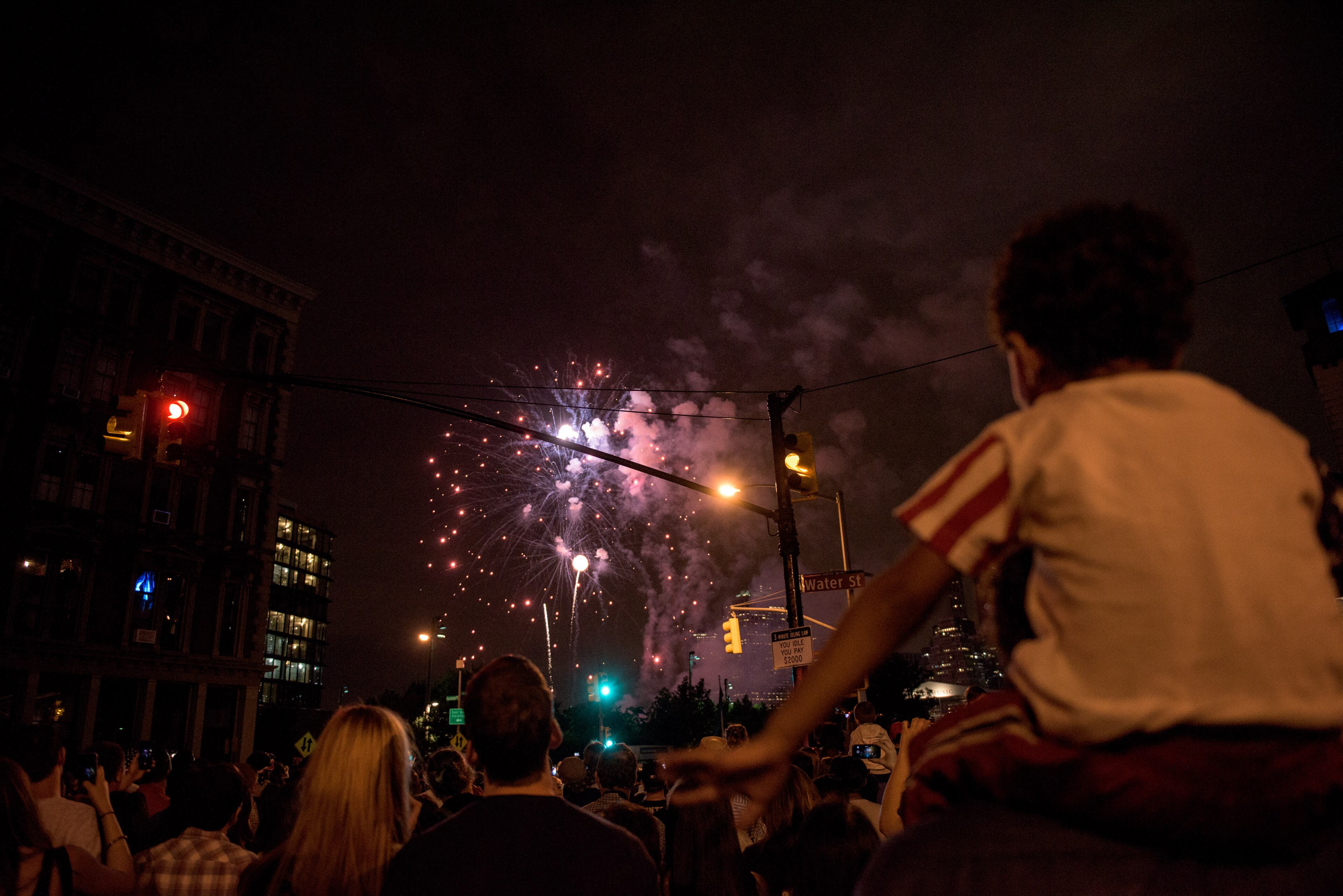 NEW YORK, NY - JULY 4: People watch the Macy's Fourth of July Fireworks from outside Brooklyn Bridge Park during , on July 4, 2015 in the Brooklyn borough of New York City. The celebrations mark the nation's 239th Independence Day. (Photo by Andrew Renneisen/Getty Images)