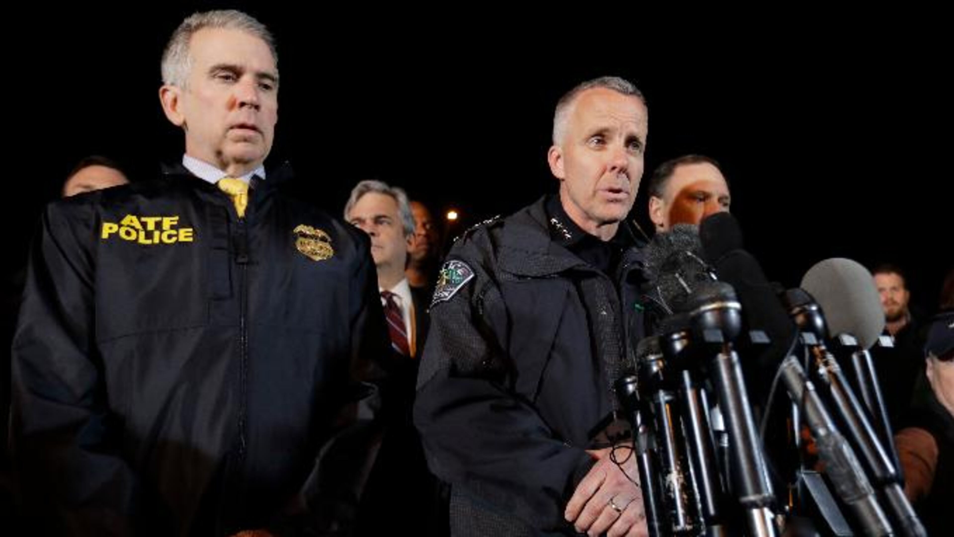 Interim Austin Police Chief Brian Manley, right, stands with other members of law enforcement as he briefs the media, Wednesday, March 21, 2018, in the Austin suburb of Round Rock, Texas. The suspect in a spate of bombing attacks that have terrorized Austin over the past month blew himself up with an explosive device as authorities closed in, the police said early Wednesday.