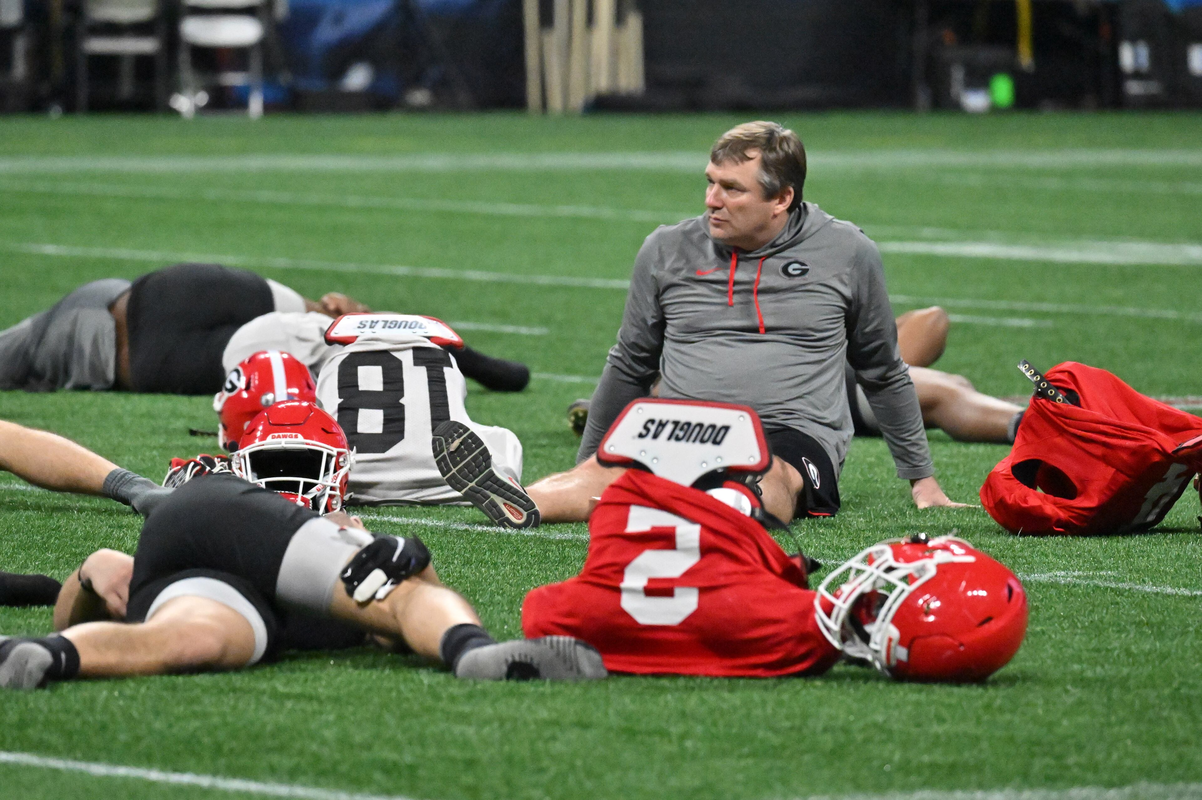 Georgia's head coach Kirby Smart watches as players stretch during a practice session for the Chick-fil-A Peach Bowl game against Ohio State at the Mercedes-Benz Stadium on Thursday, Dec. 29, 2022, in Atlanta. (Hyosub Shin / Hyosub.Shin@ajc.com)