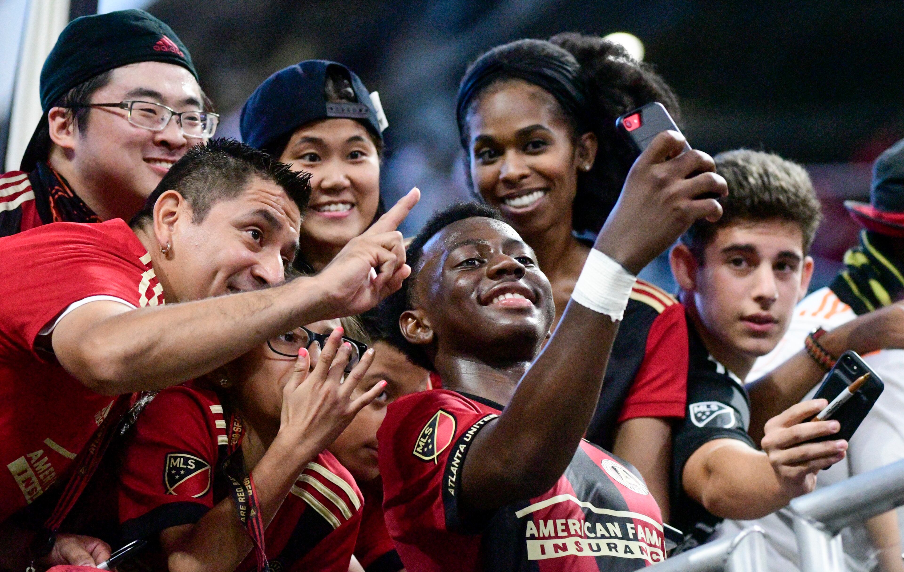 Atlanta United defender George Bello takes a selfie with fans after an MLS soccer game against the New England Revolution, Saturday, Oct. 6, 2018. Atlanta won 2-1. (John Amis)