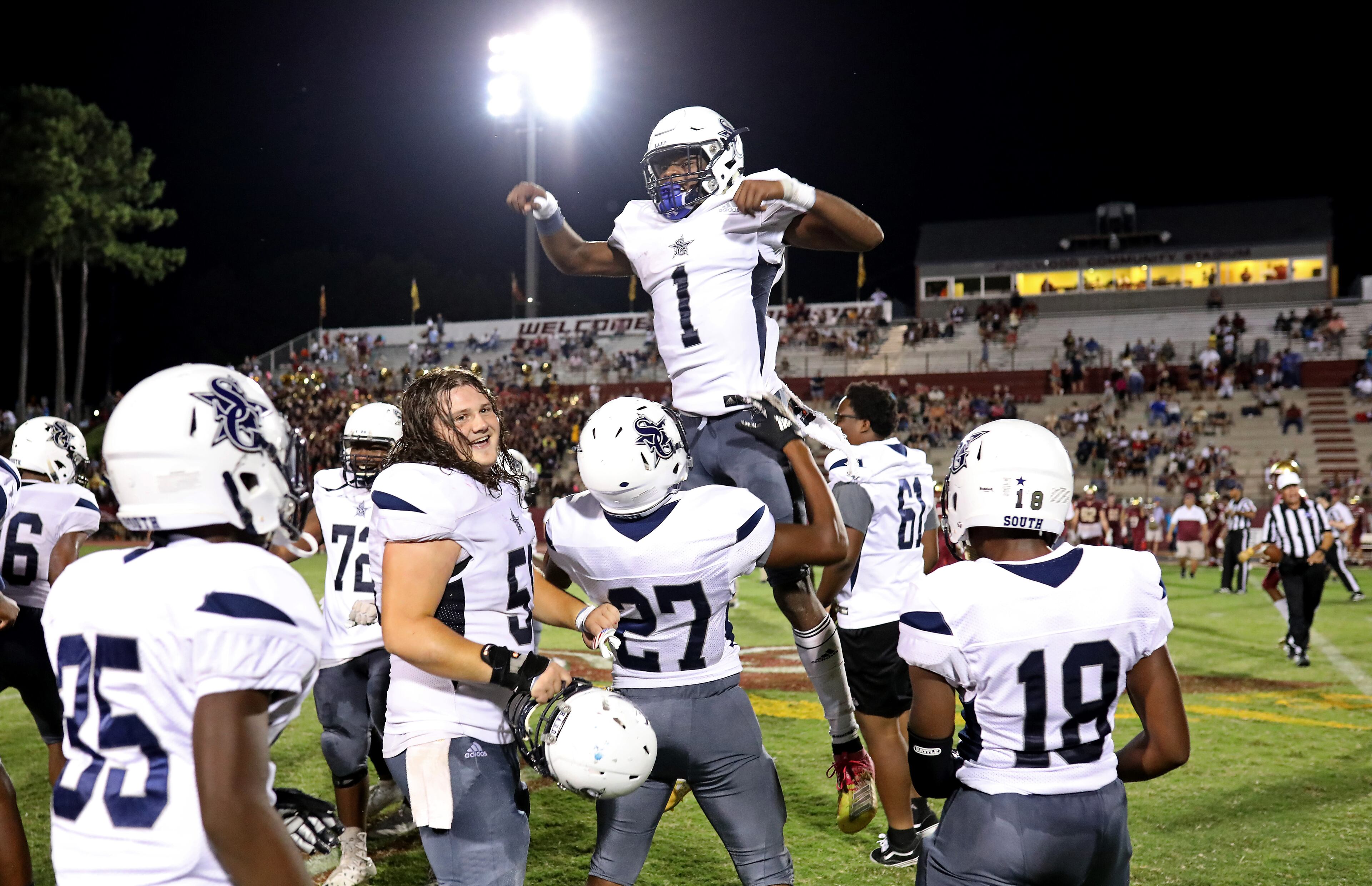 South Gwinnett quarterback Tre Truitt (1) celebrates with Caleb Pedro (27) after they defeated Brookwood 35-21 Friday in Snellville. (Jason Getz/Special)