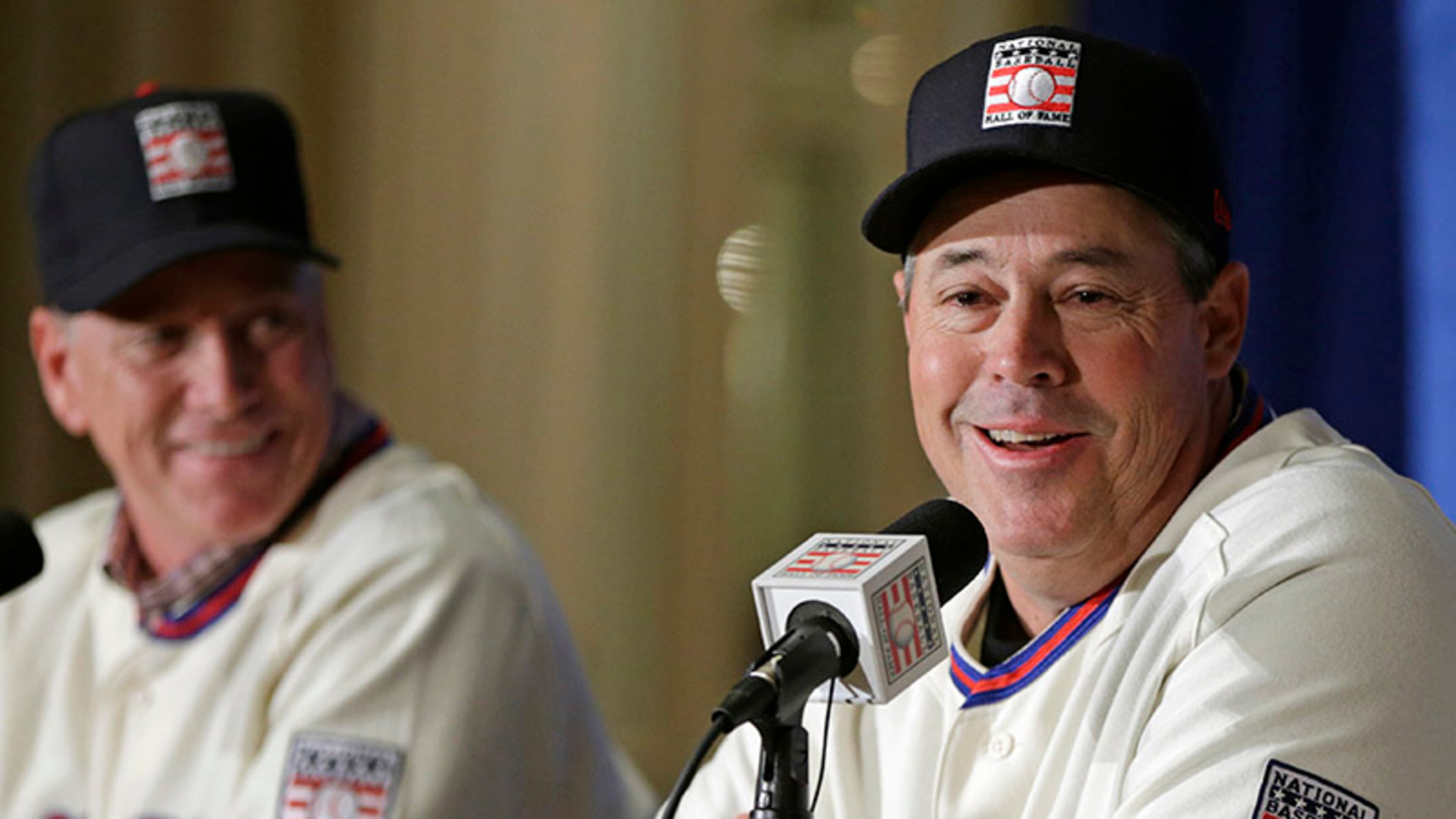 Former Braves pitcher Greg Maddux, who will enter the Hall of Fame along with Tom Glavine (background) and manager Bobby Cox, will not have a Braves logo on his cap.