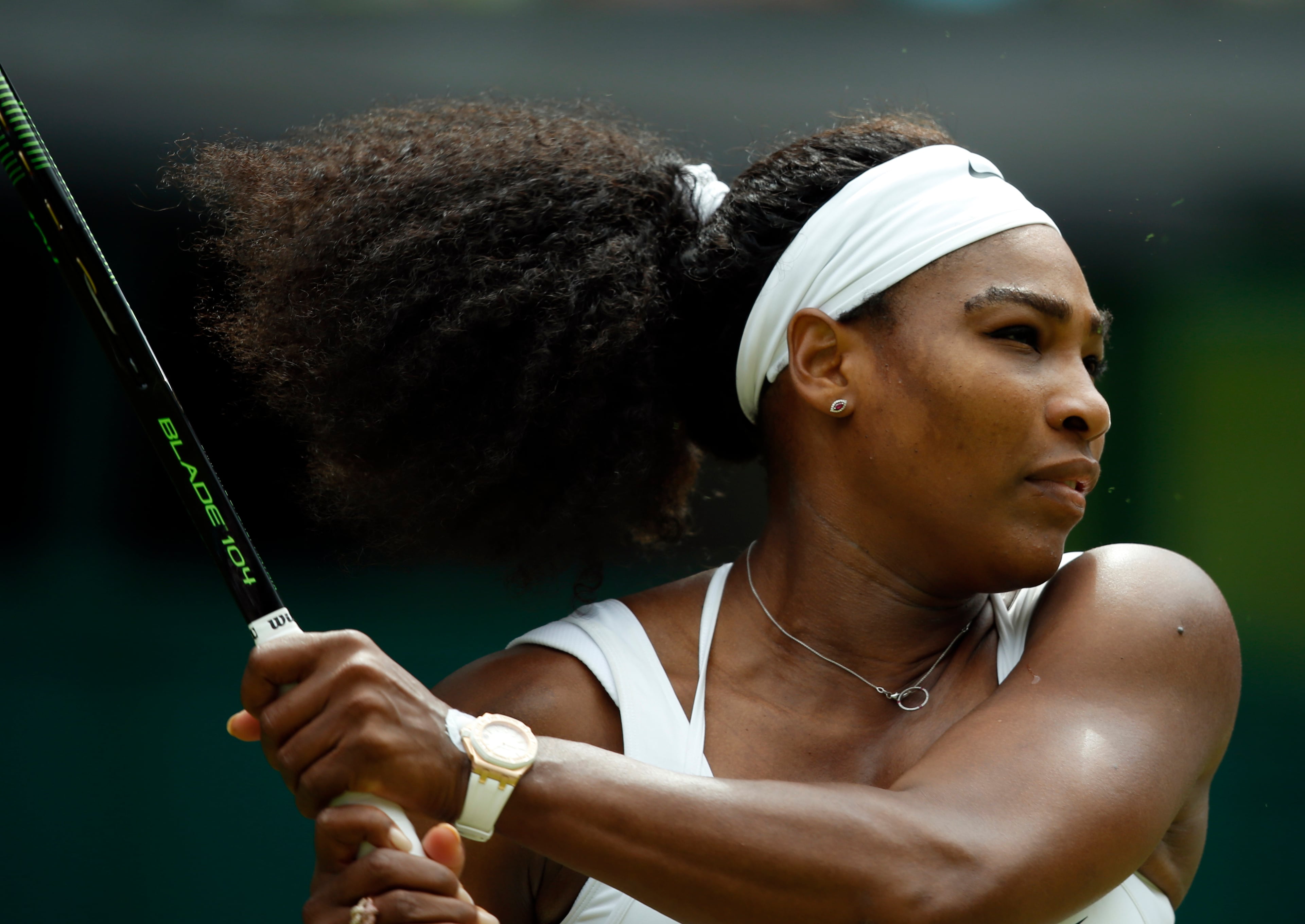 Serena Williams of the United States makes a return to Venus Williams of the United States, during their singles match against at the All England Lawn Tennis Championships in Wimbledon, London, Monday July 6, 2015. (AP Photo/Alastair Grant)